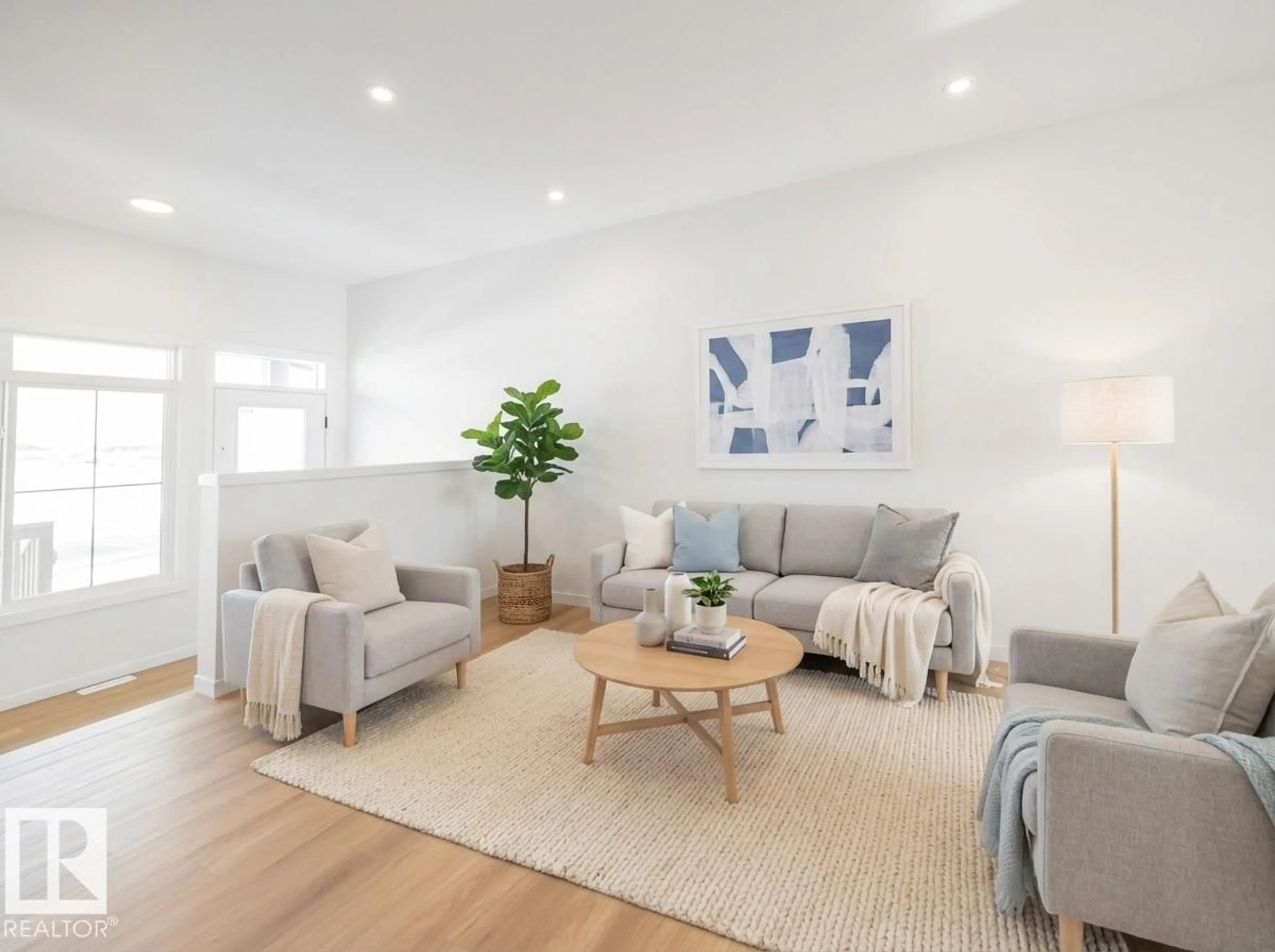 Living room with furniture, wood/laminate floor for 631 173 AV, Edmonton Alberta T5Y4E8