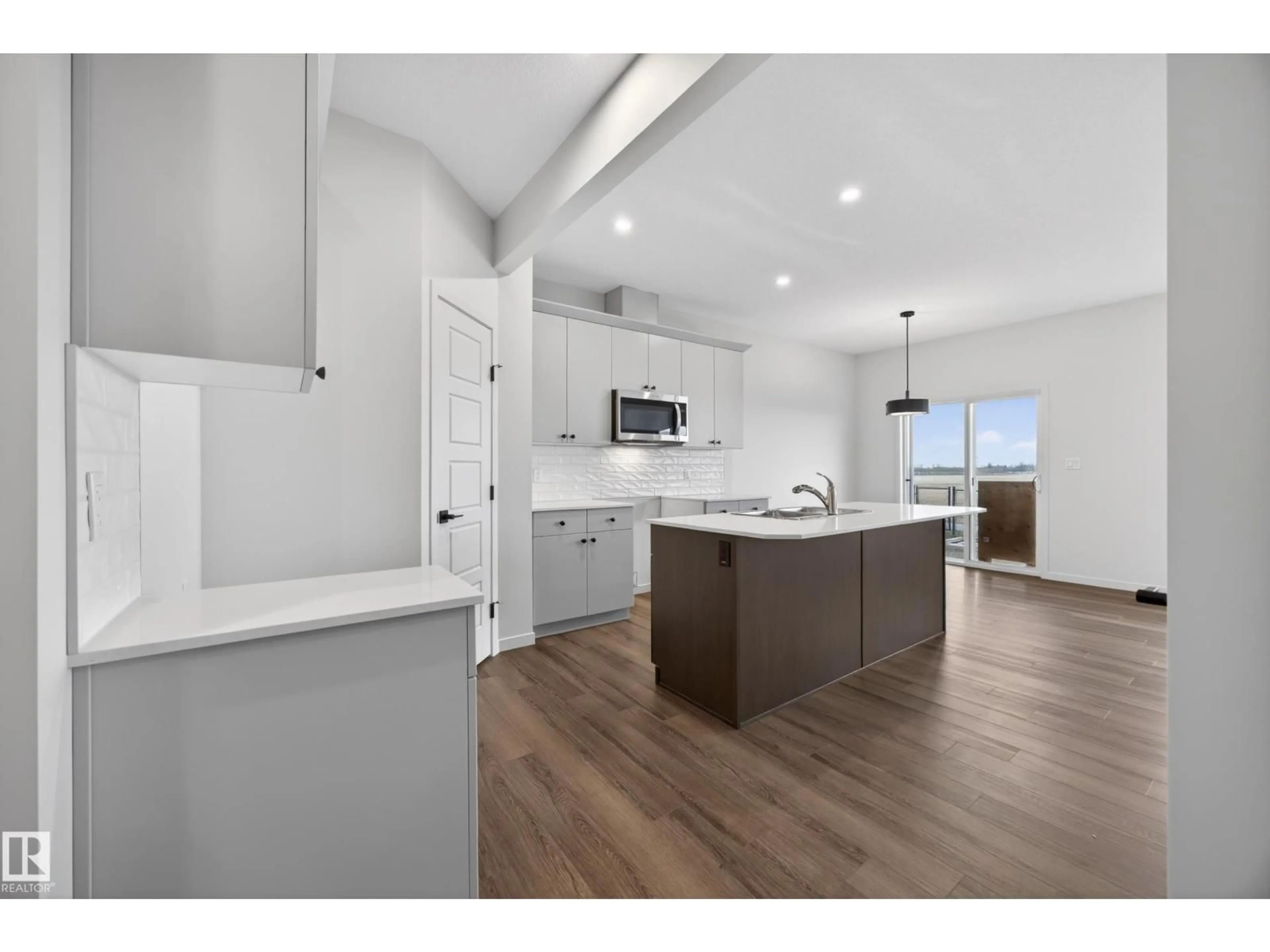 Open concept kitchen, wood/laminate floor for 284 LODGE POLE PL, Leduc Alberta T9E0K7