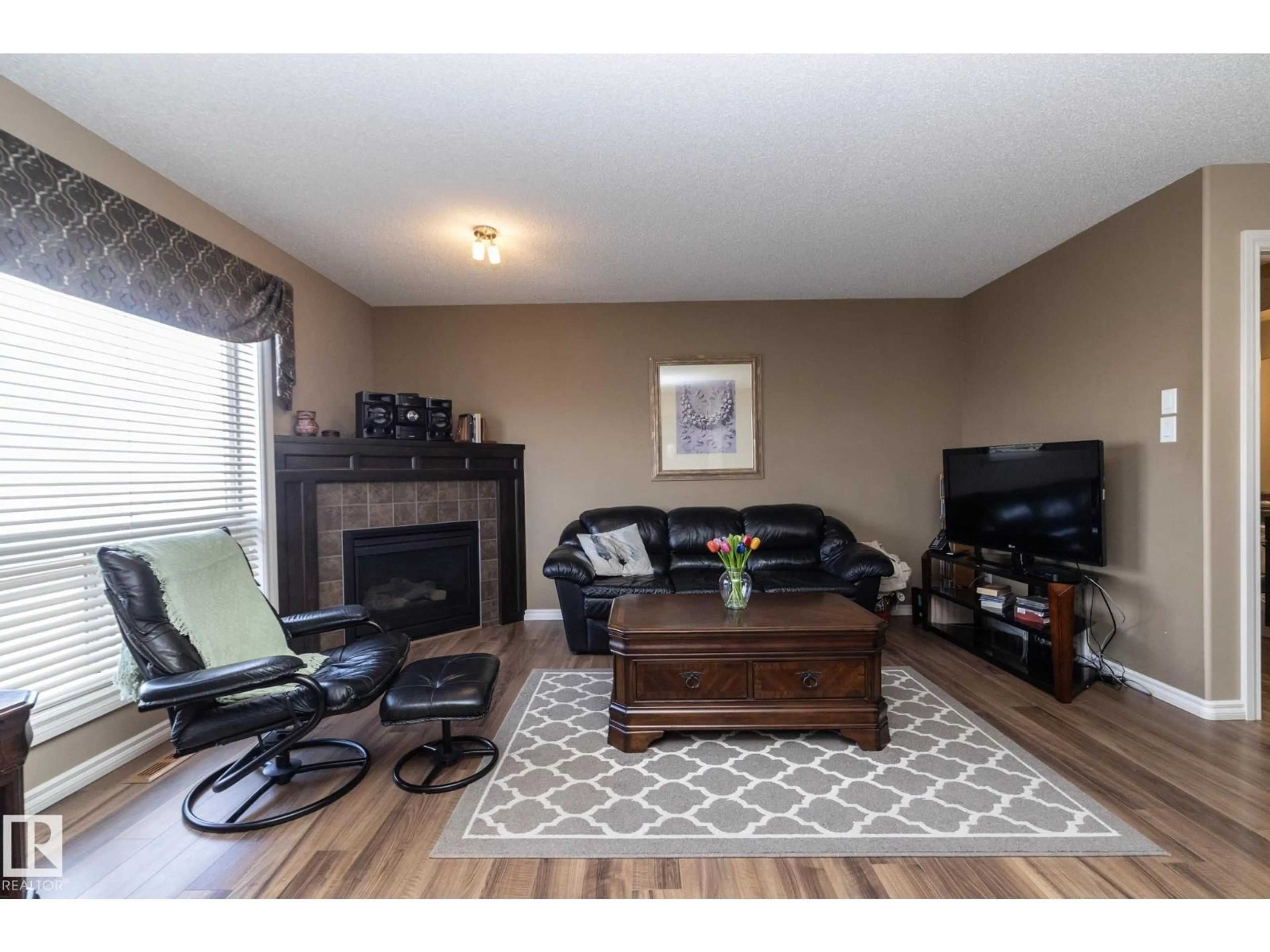 Living room with furniture, wood/laminate floor for 130 KIRPATRICK WY, Leduc Alberta T9E0Z2