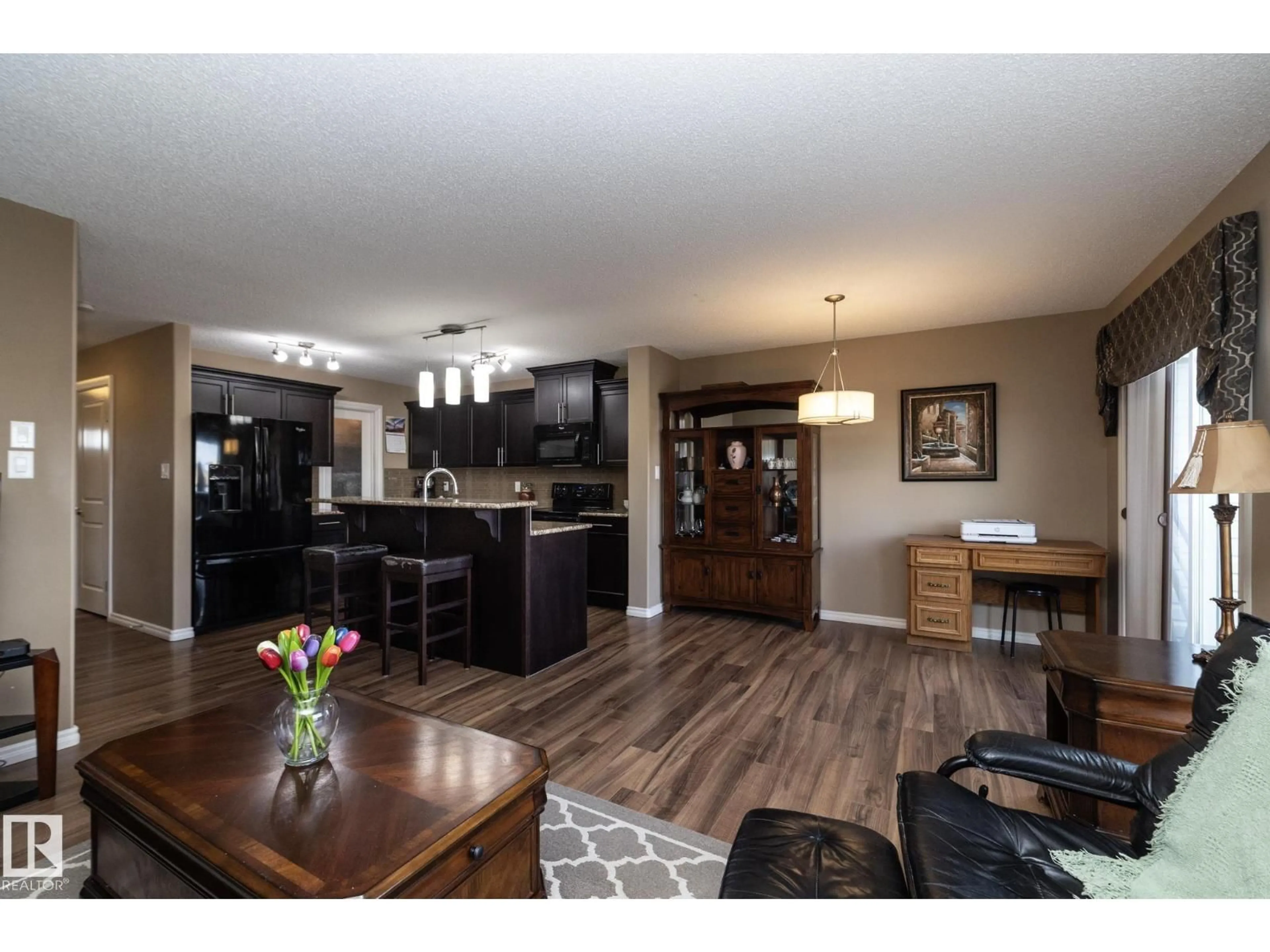 Open concept kitchen, wood/laminate floor for 130 KIRPATRICK WY, Leduc Alberta T9E0Z2