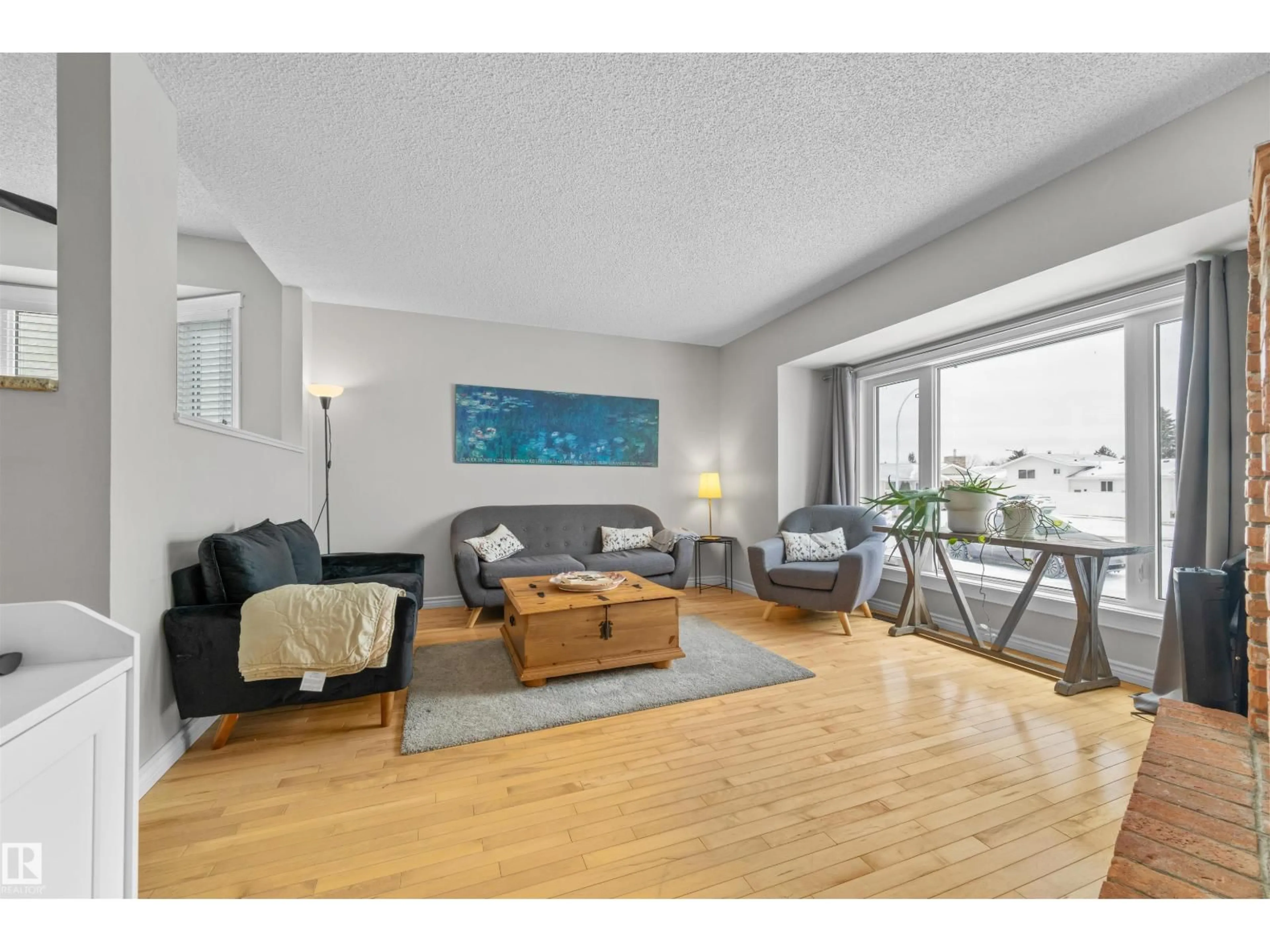Living room with furniture, wood/laminate floor for 1127 36 ST, Edmonton Alberta T6L2L6