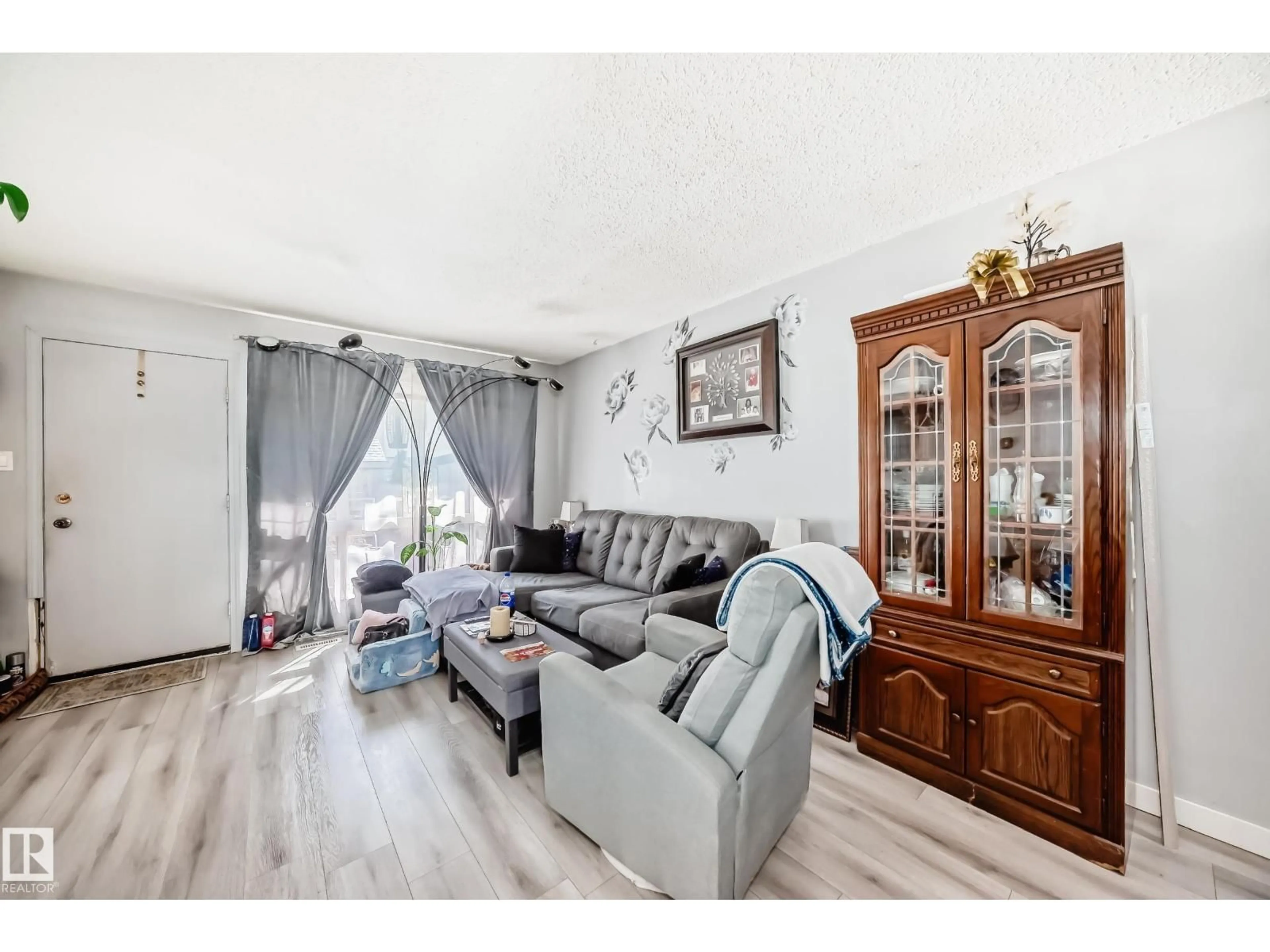 Living room with furniture, wood/laminate floor for 582 ABBOTTSFIELD RD, Edmonton Alberta T5W4R3