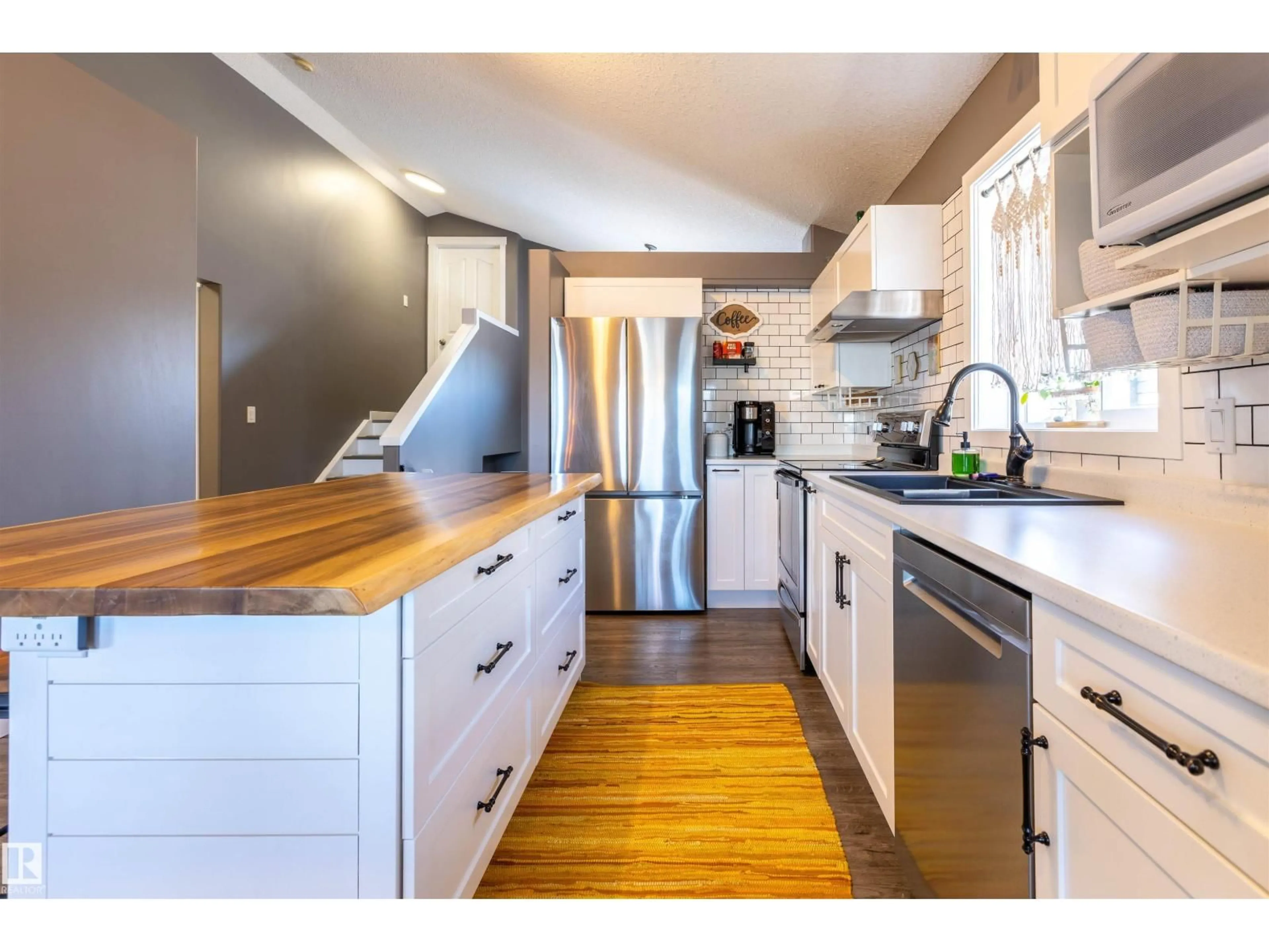 Open concept kitchen, wood/laminate floor for 9719 87 ST, Morinville Alberta T8R1V2