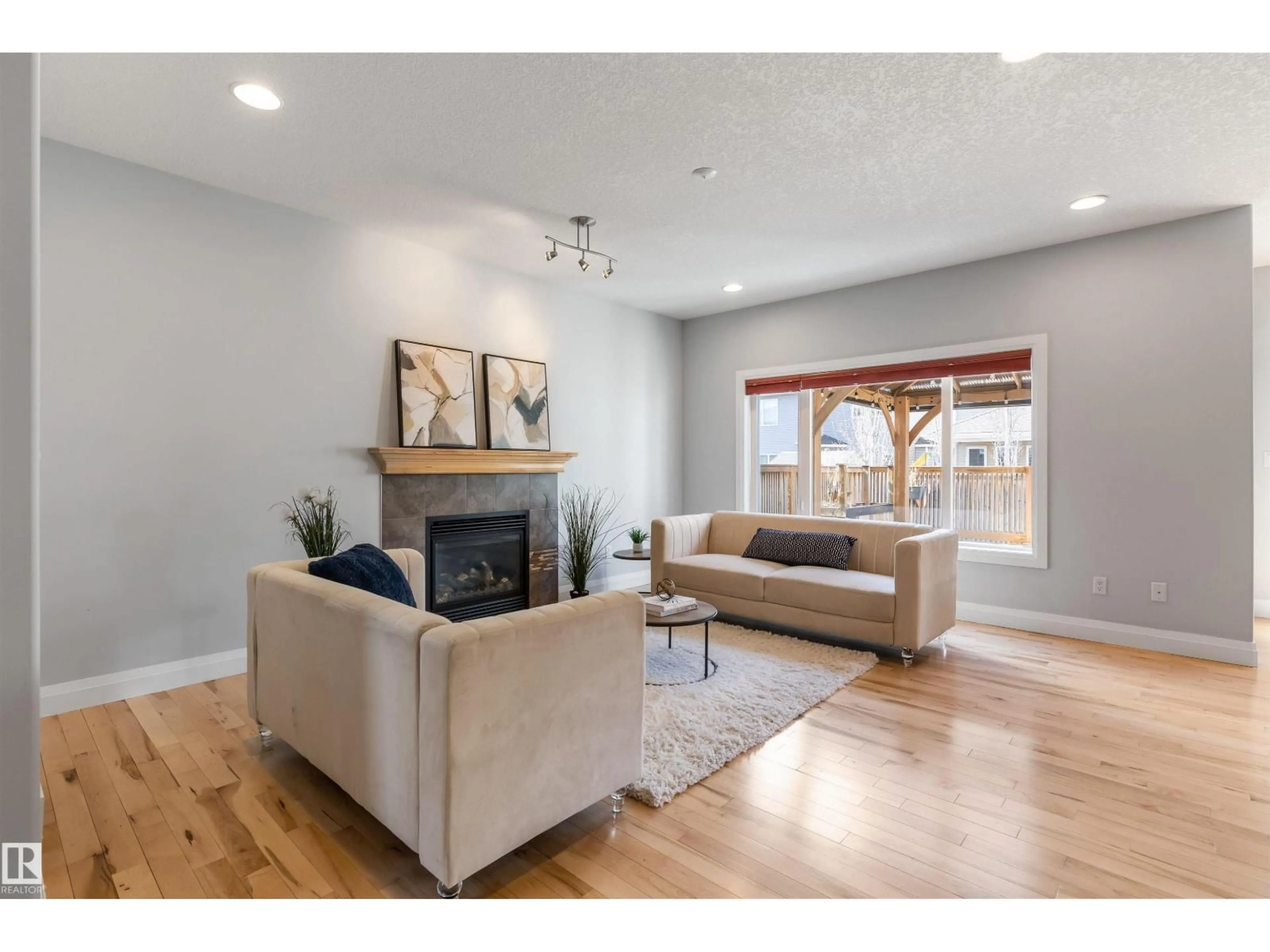 Living room with furniture, wood/laminate floor for 8910 97 AV, Morinville Alberta T8R2N7