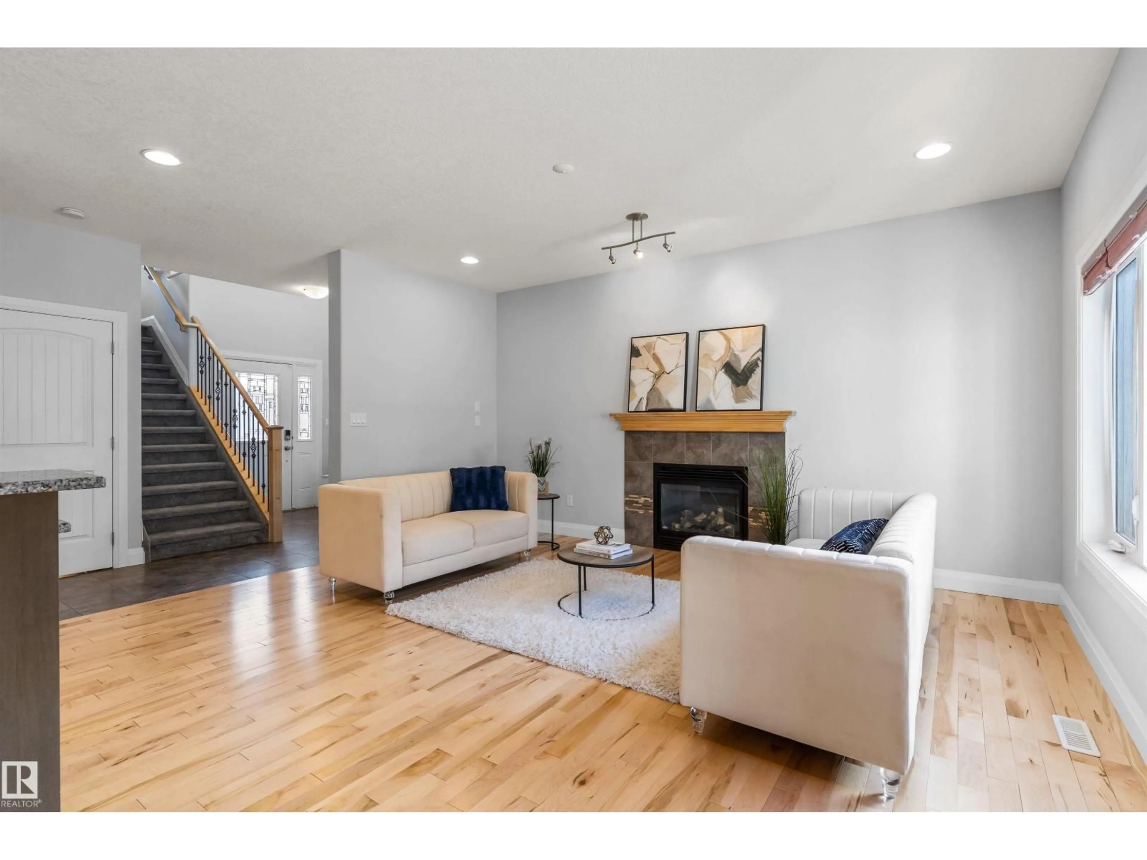 Living room with furniture, wood/laminate floor for 8910 97 AV, Morinville Alberta T8R2N7