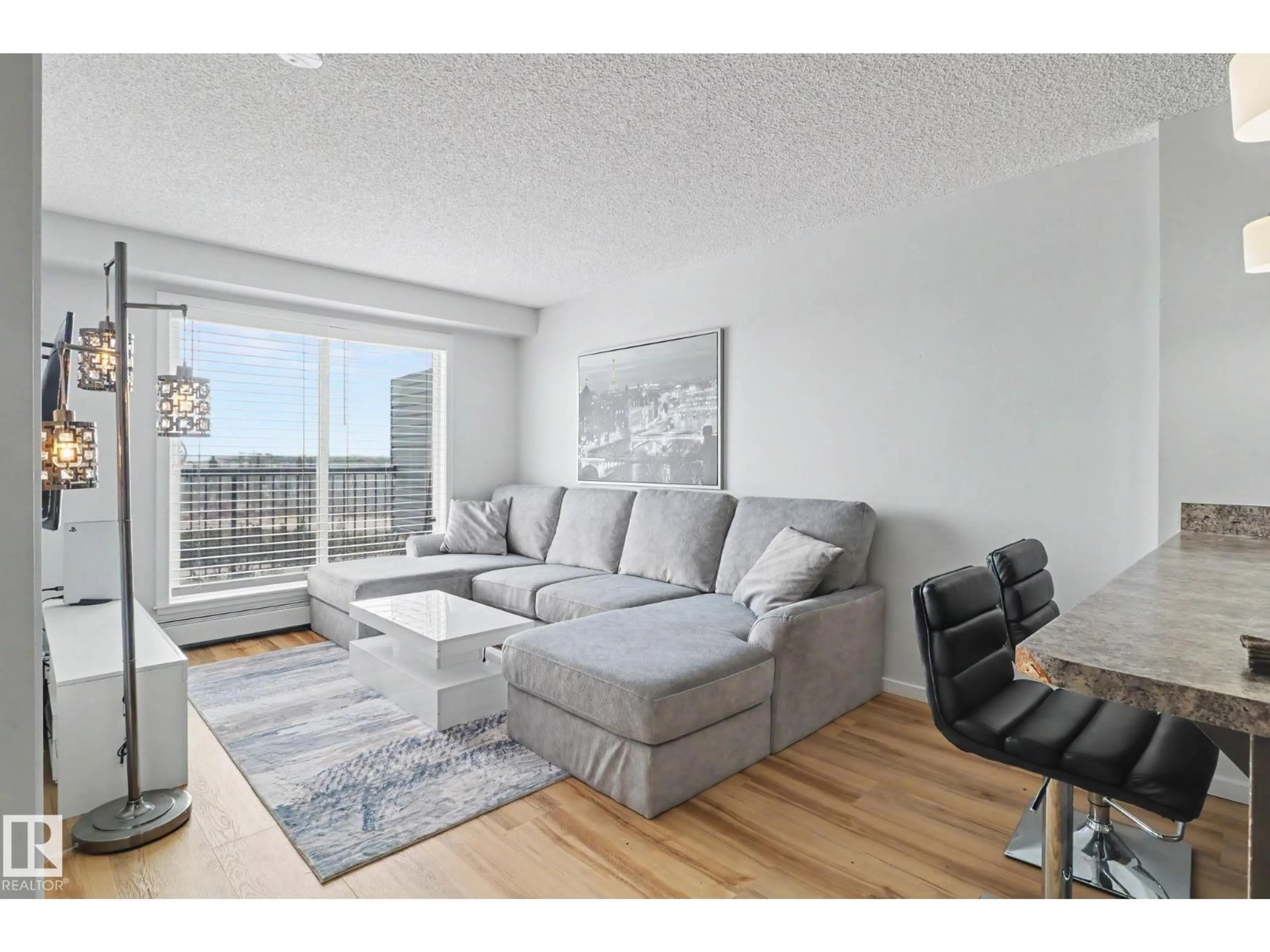 Living room with furniture, wood/laminate floor for 451 1196 HYNDMAN RD, Edmonton Alberta T5A0X8