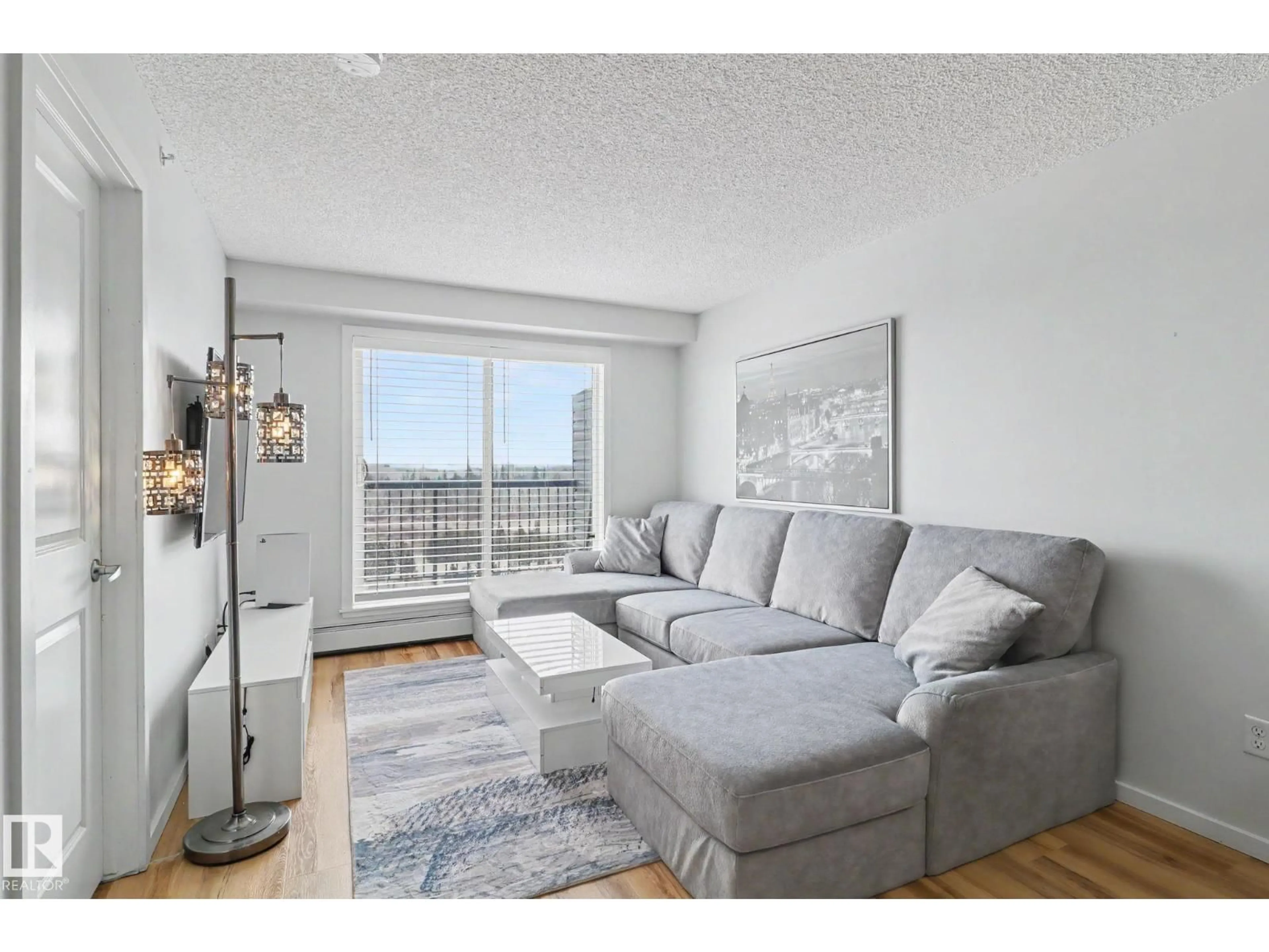 Living room with furniture, wood/laminate floor for 451 1196 HYNDMAN RD, Edmonton Alberta T5A0X8
