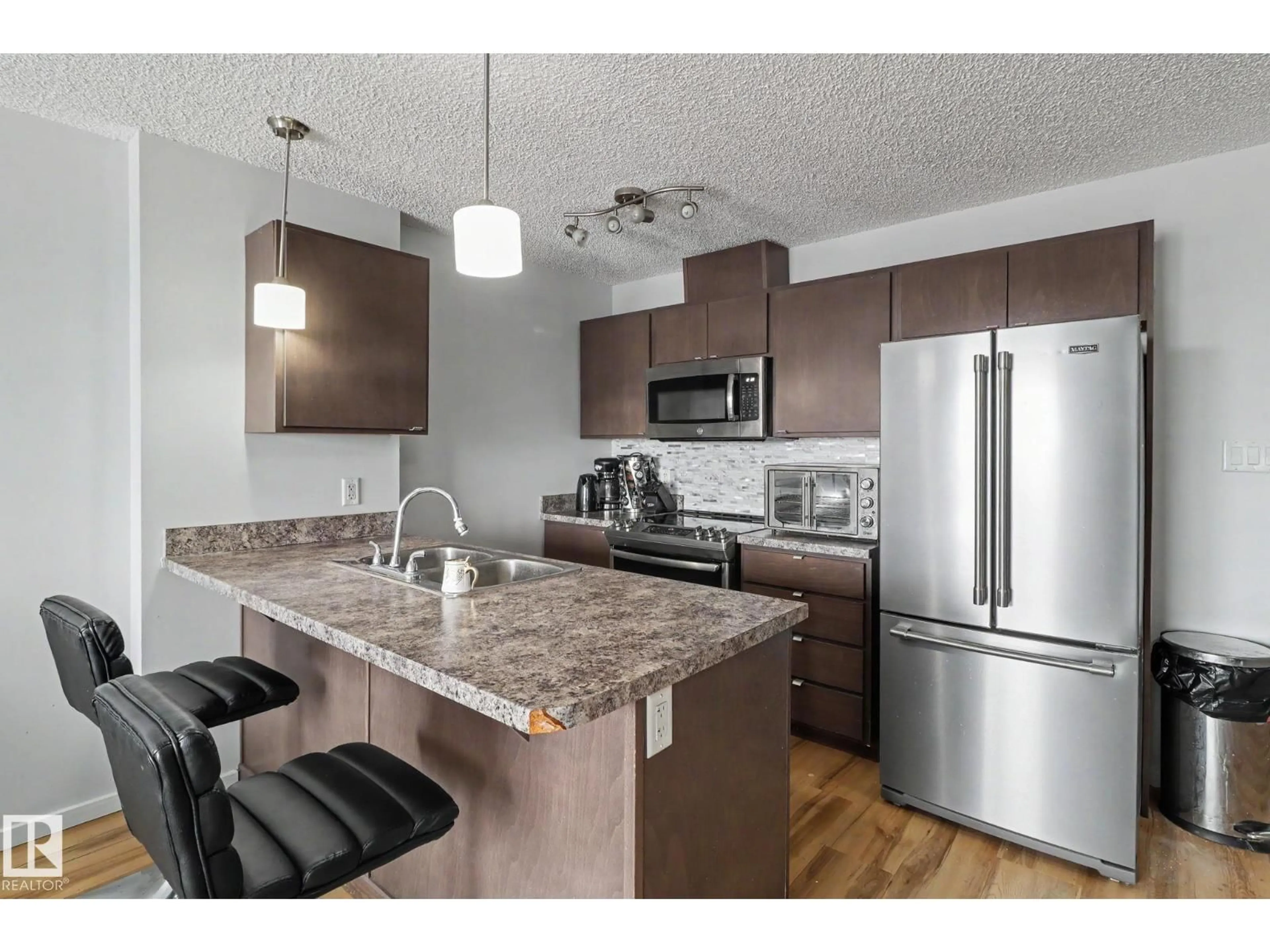 Open concept kitchen, wood/laminate floor for 451 1196 HYNDMAN RD, Edmonton Alberta T5A0X8