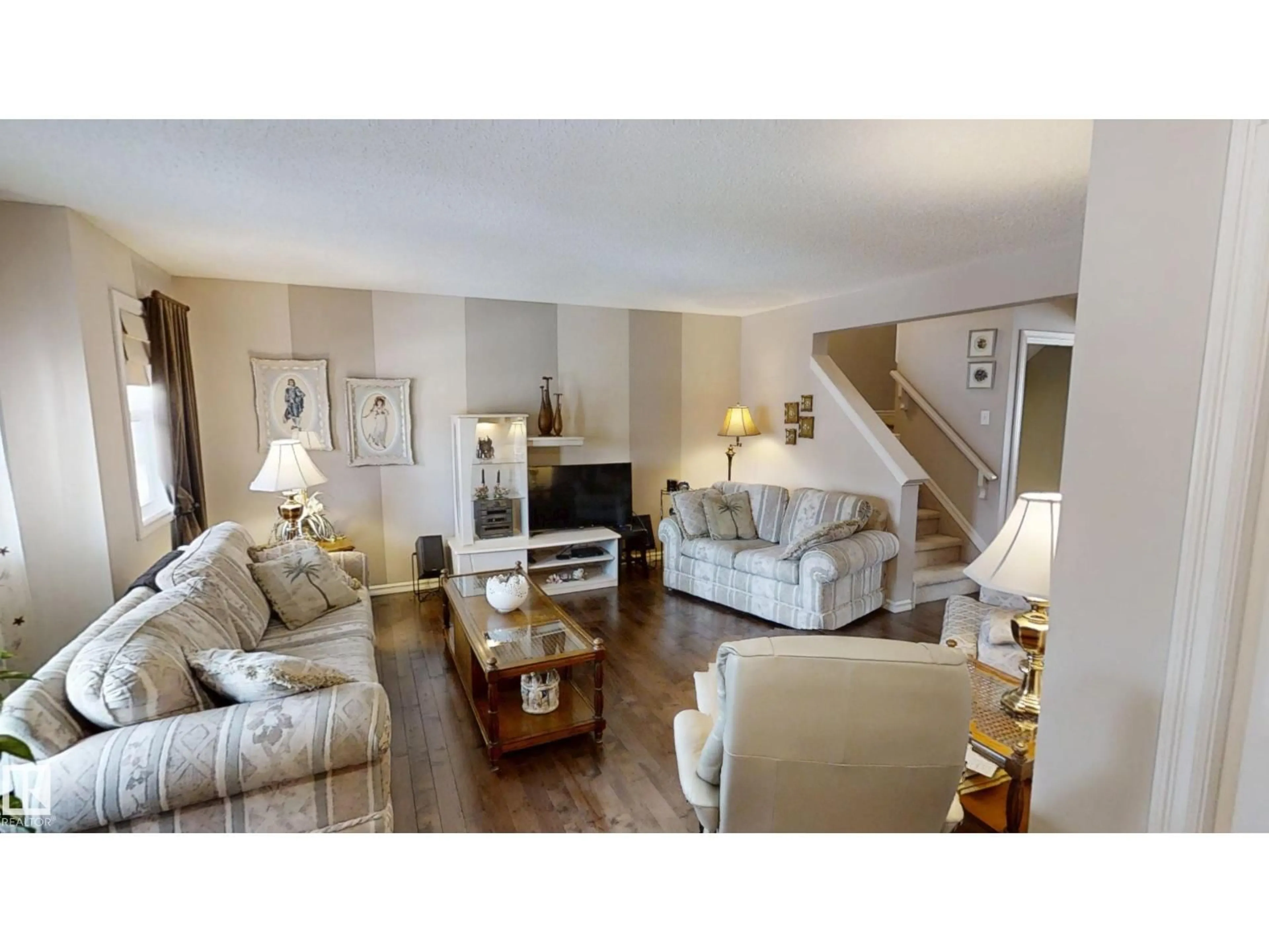 Living room with furniture, wood/laminate floor for 8627 173 AV, Edmonton Alberta T5Z3W4