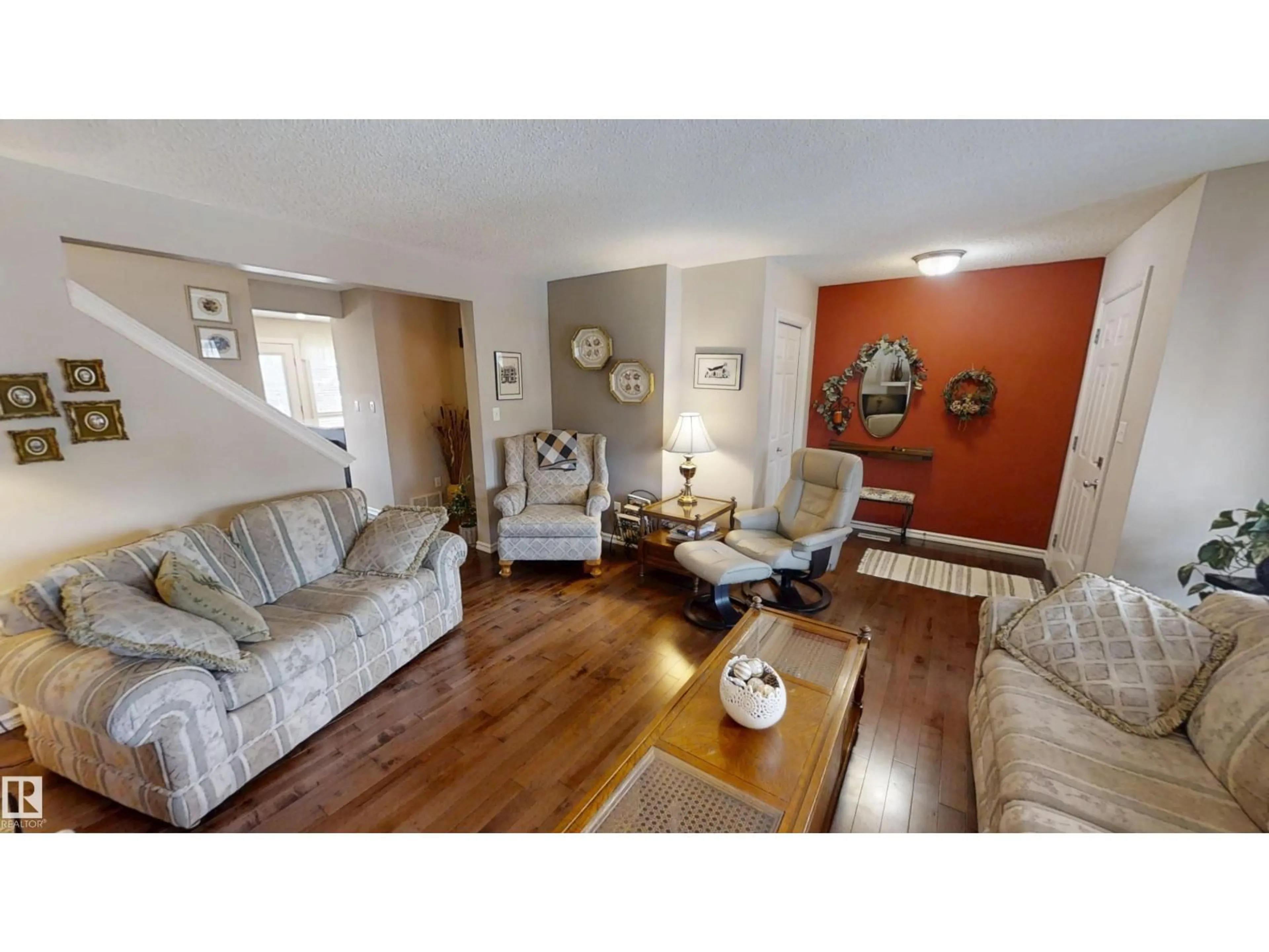 Living room with furniture, wood/laminate floor for 8627 173 AV, Edmonton Alberta T5Z3W4