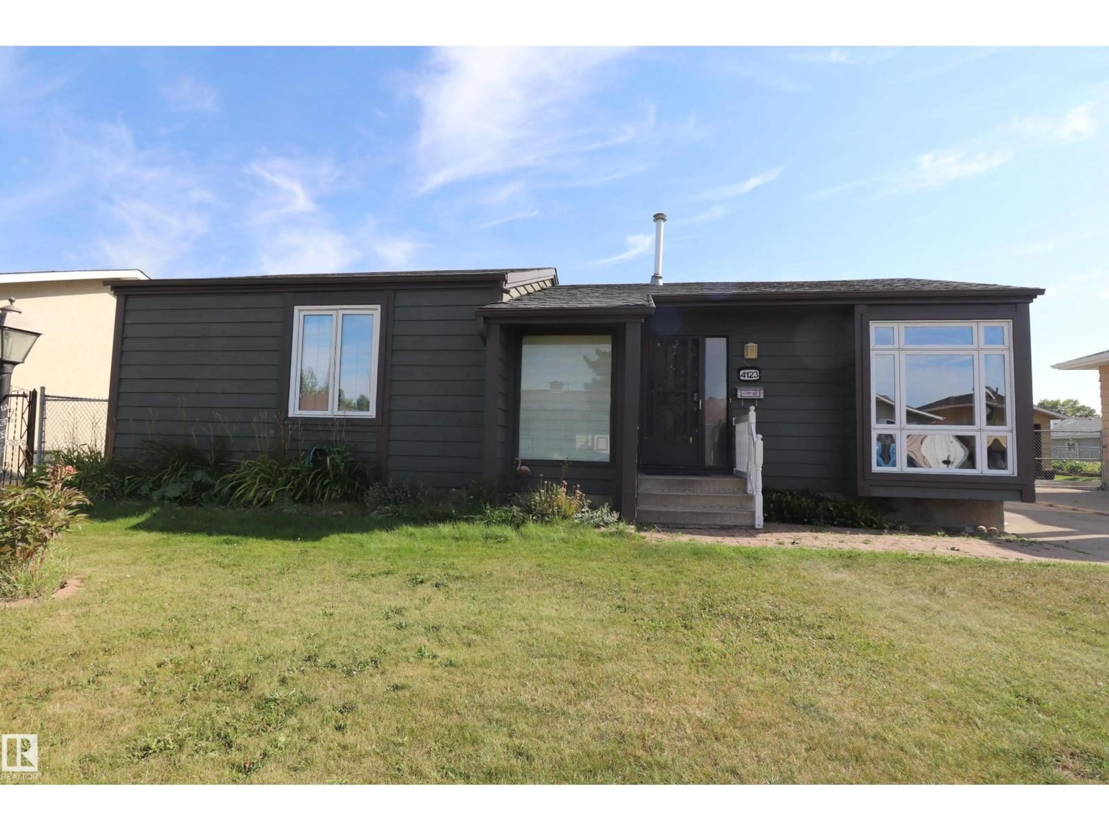 Home with vinyl exterior material, street for 4123 136 AV, Edmonton Alberta T5A2N9