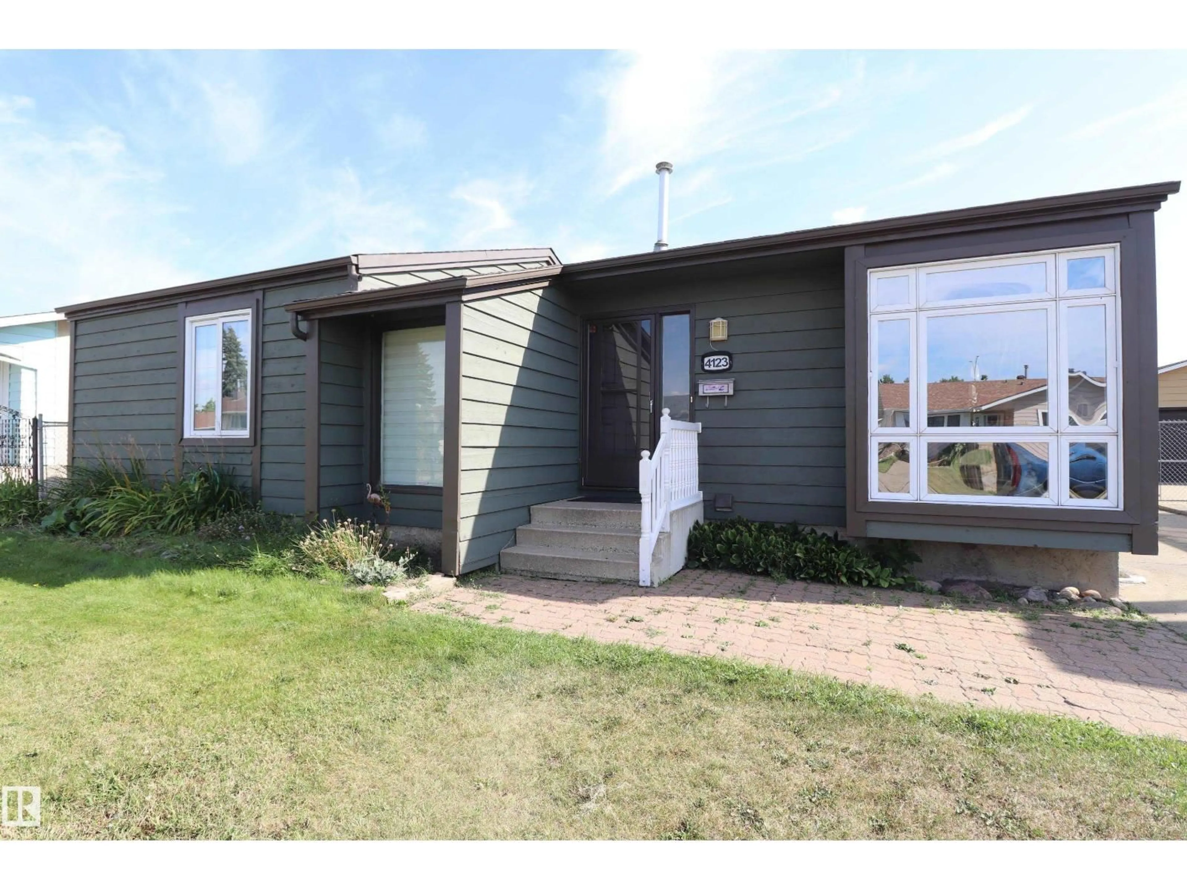 Home with vinyl exterior material, street for 4123 136 AV, Edmonton Alberta T5A2N9