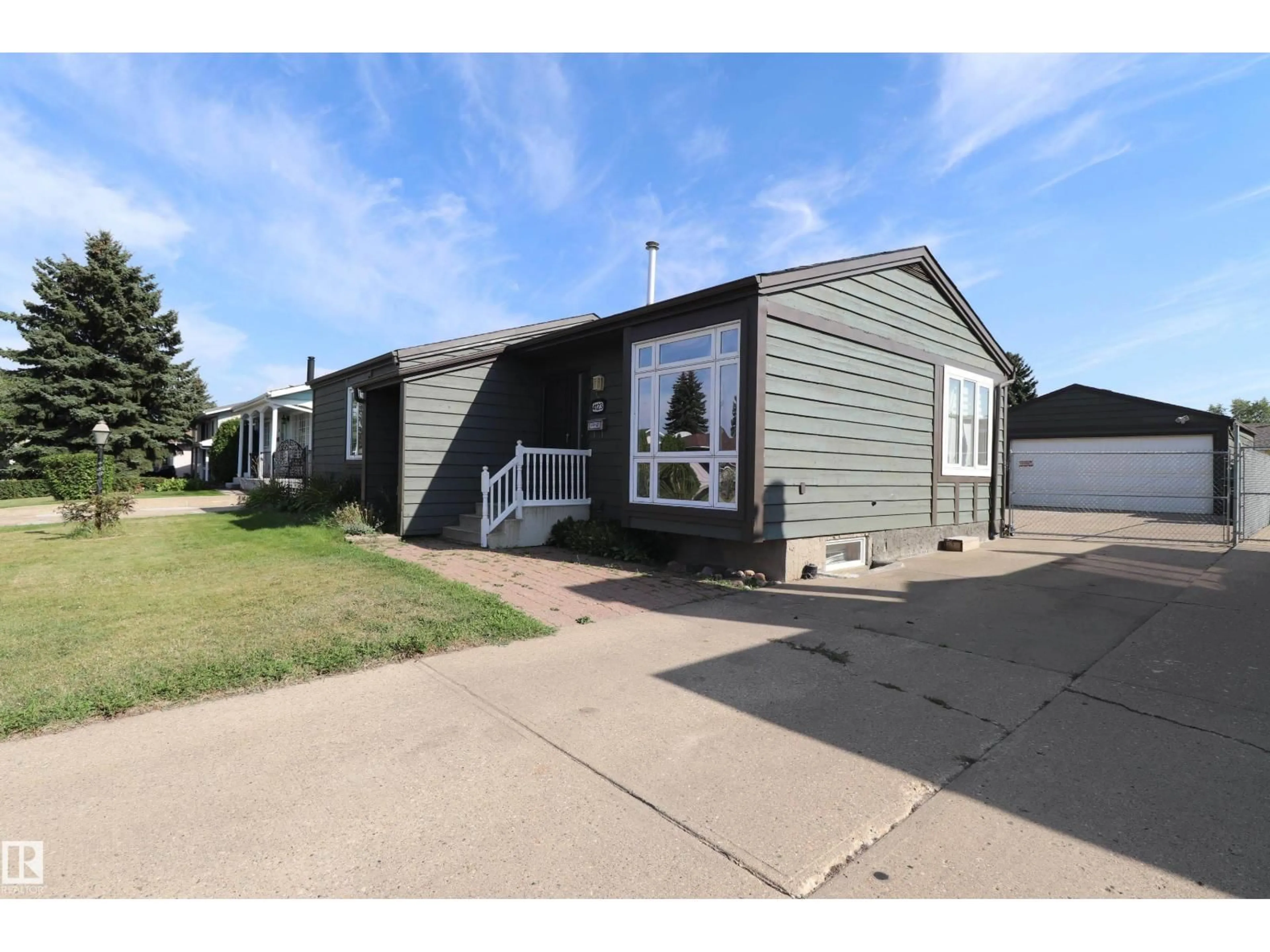Home with vinyl exterior material, street for 4123 136 AV, Edmonton Alberta T5A2N9