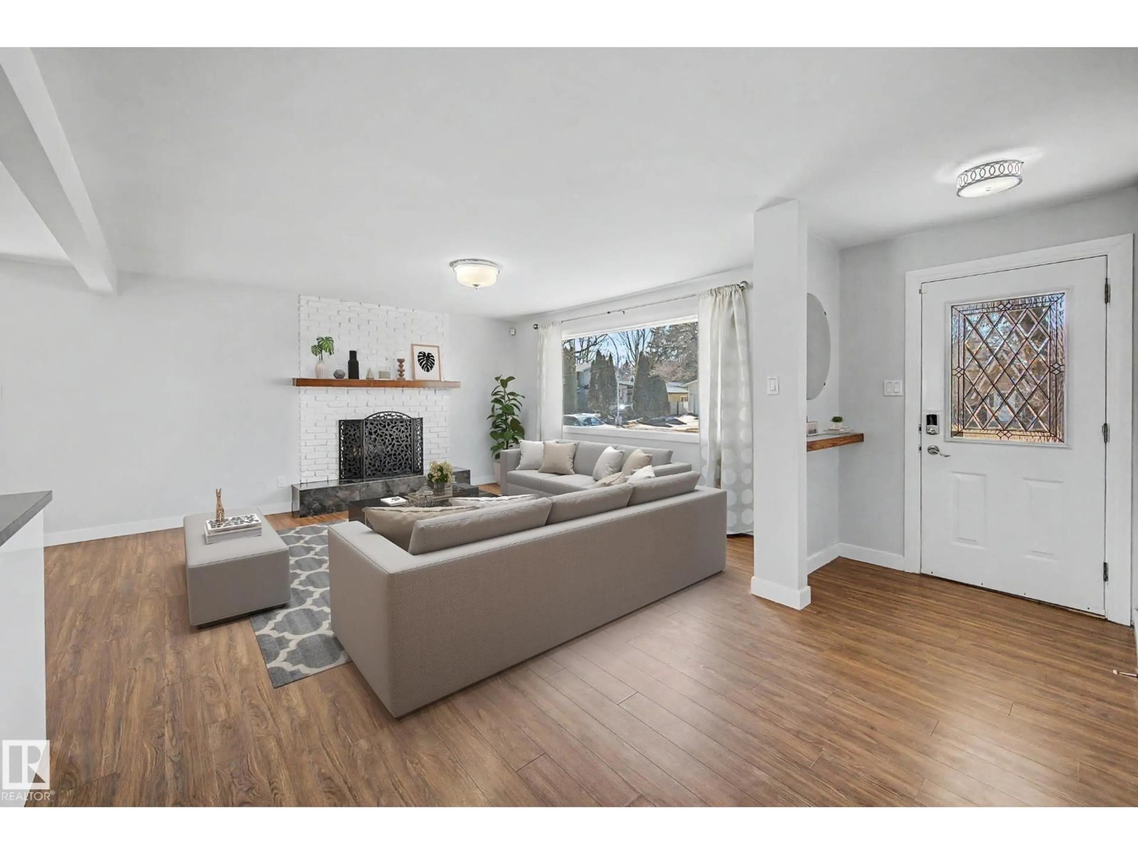 Living room with furniture, wood/laminate floor for NW - 7815 156 ST, Edmonton Alberta T5R1X6