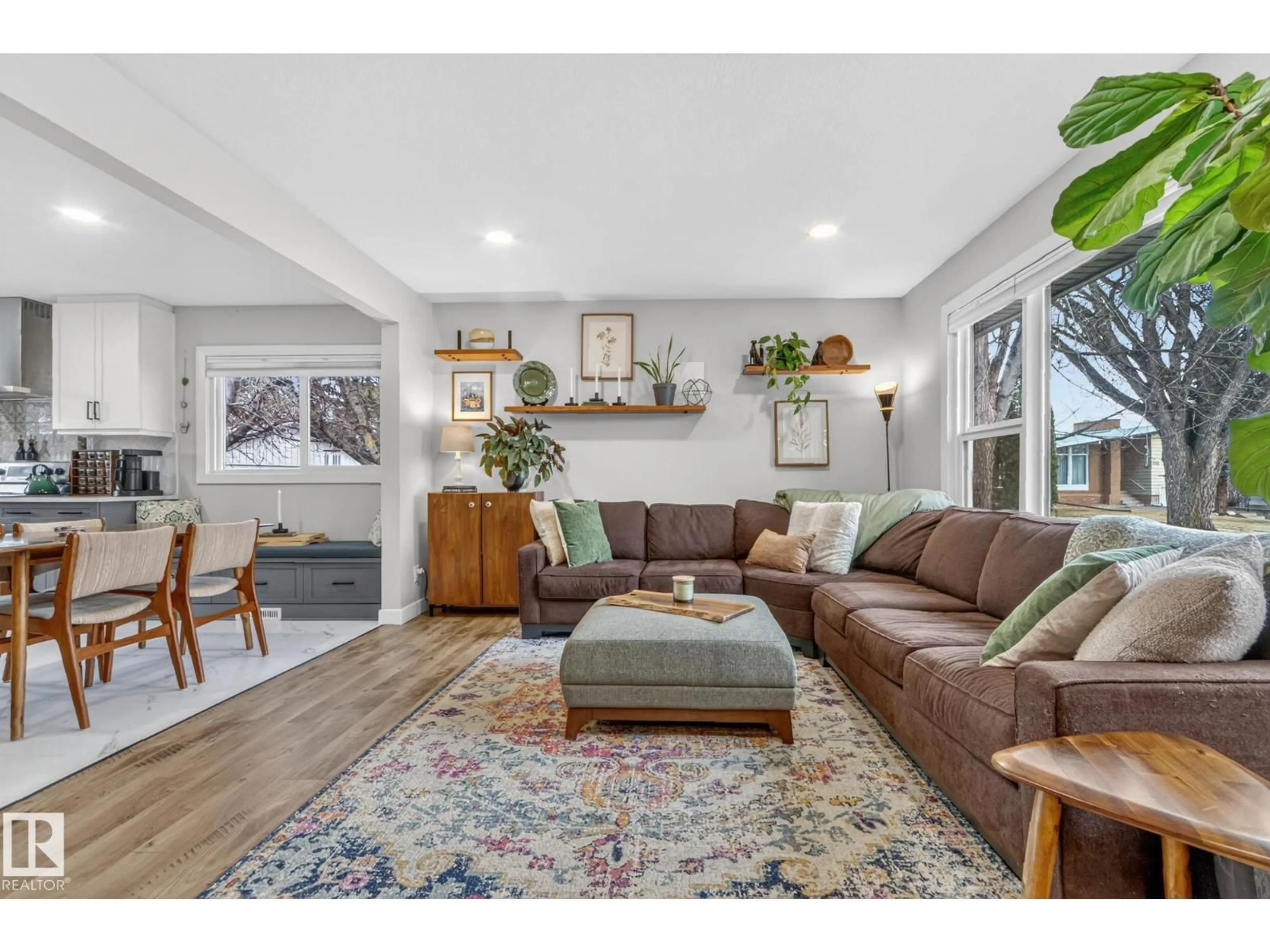 Living room with furniture, wood/laminate floor for 7408 92 AV, Edmonton Alberta T6B0S7