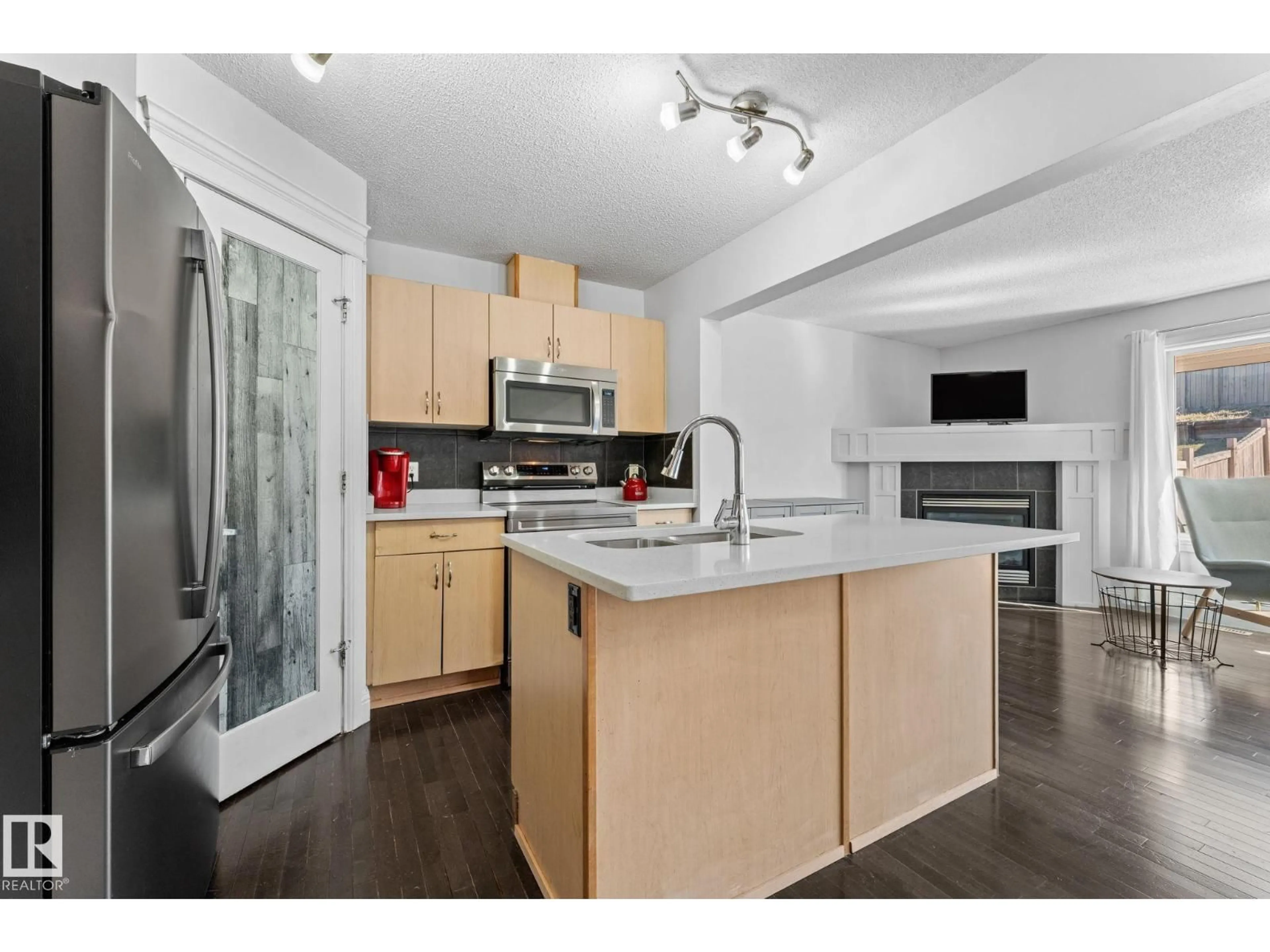 Open concept kitchen, wood/laminate floor for 3527 11 ST, Edmonton Alberta T6T0E9