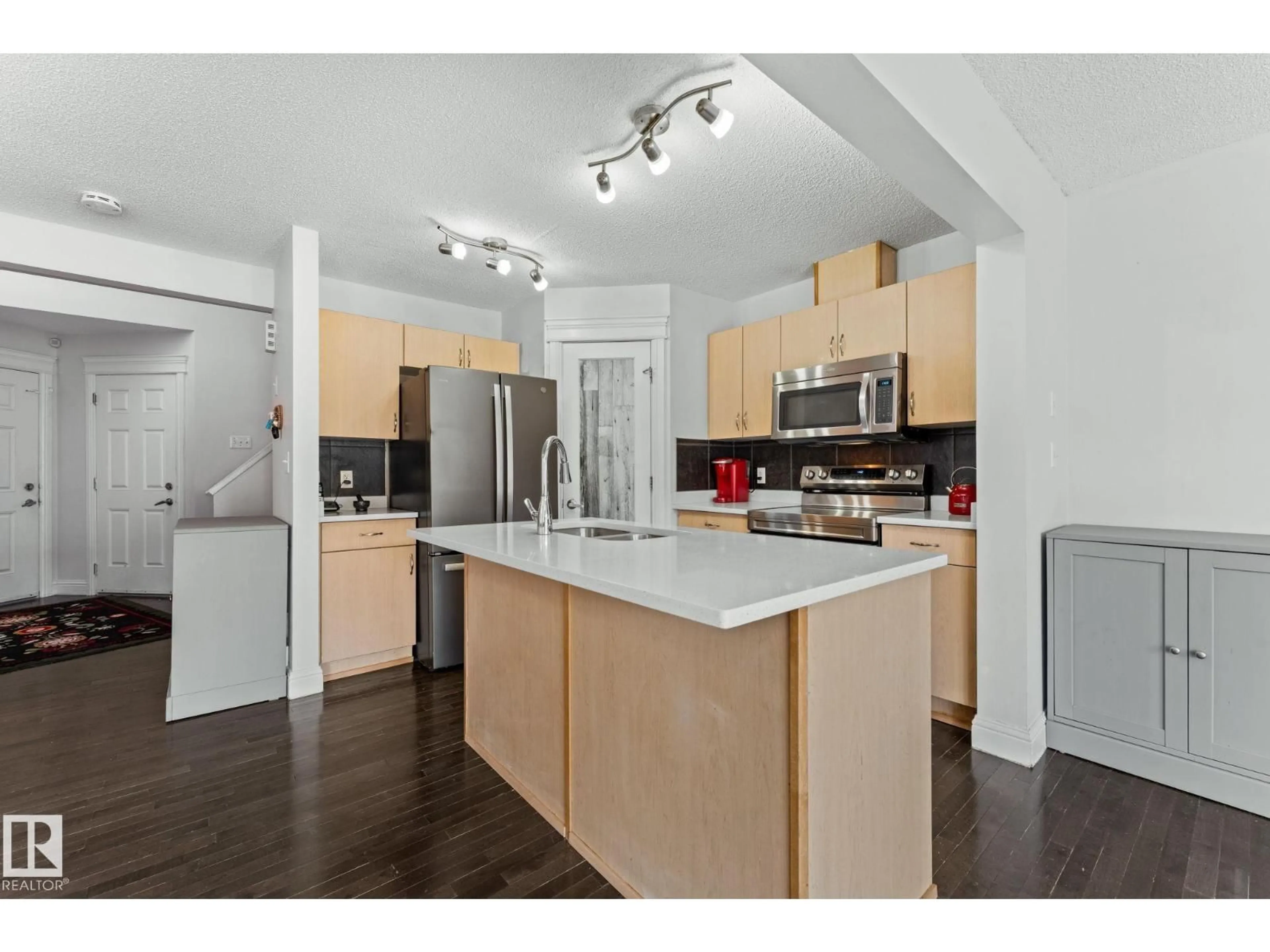 Open concept kitchen, wood/laminate floor for 3527 11 ST, Edmonton Alberta T6T0E9