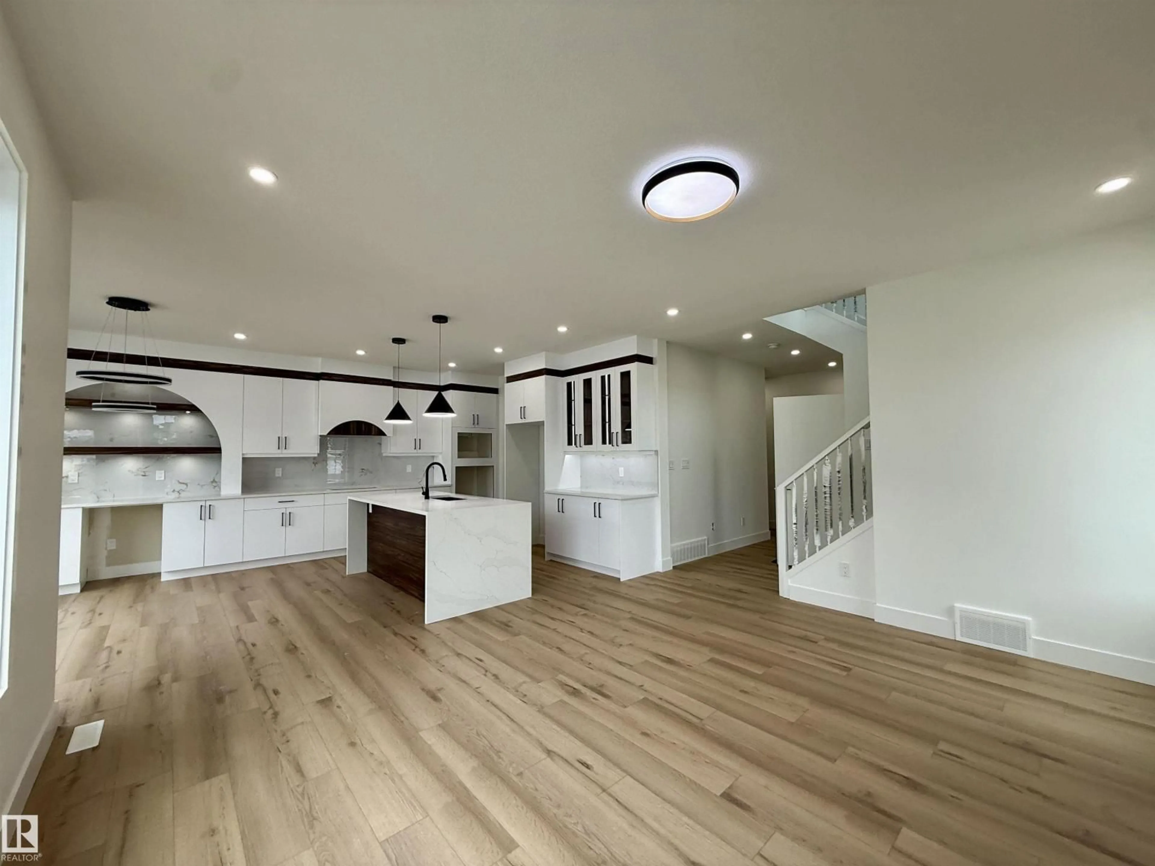 Open concept kitchen, wood/laminate floor for 5802 PELTIER CL, Beaumont Alberta T4X2Y1