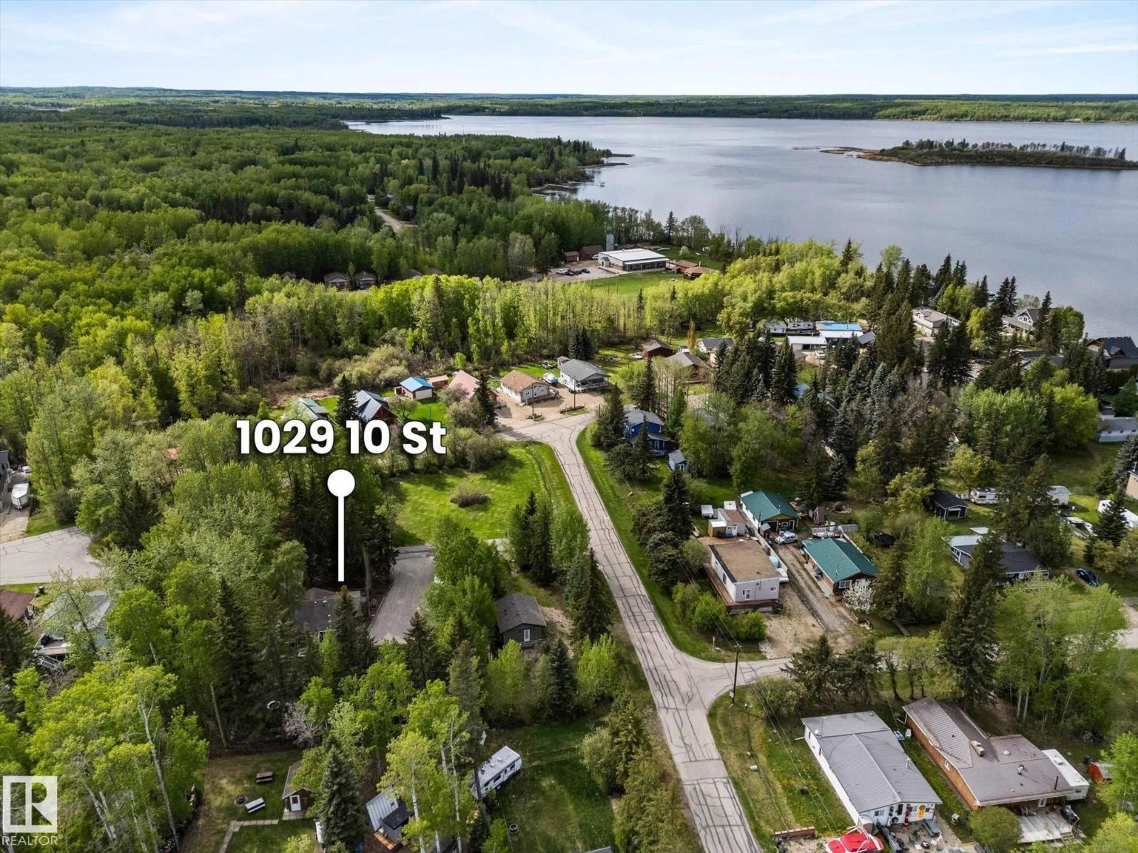 A pic from outside/outdoor area/front of a property/back of a property/a pic from drone, water/lake/river/ocean view for 1028-1029 10 ST, Rural Lac Ste. Anne County Alberta T0E0A2