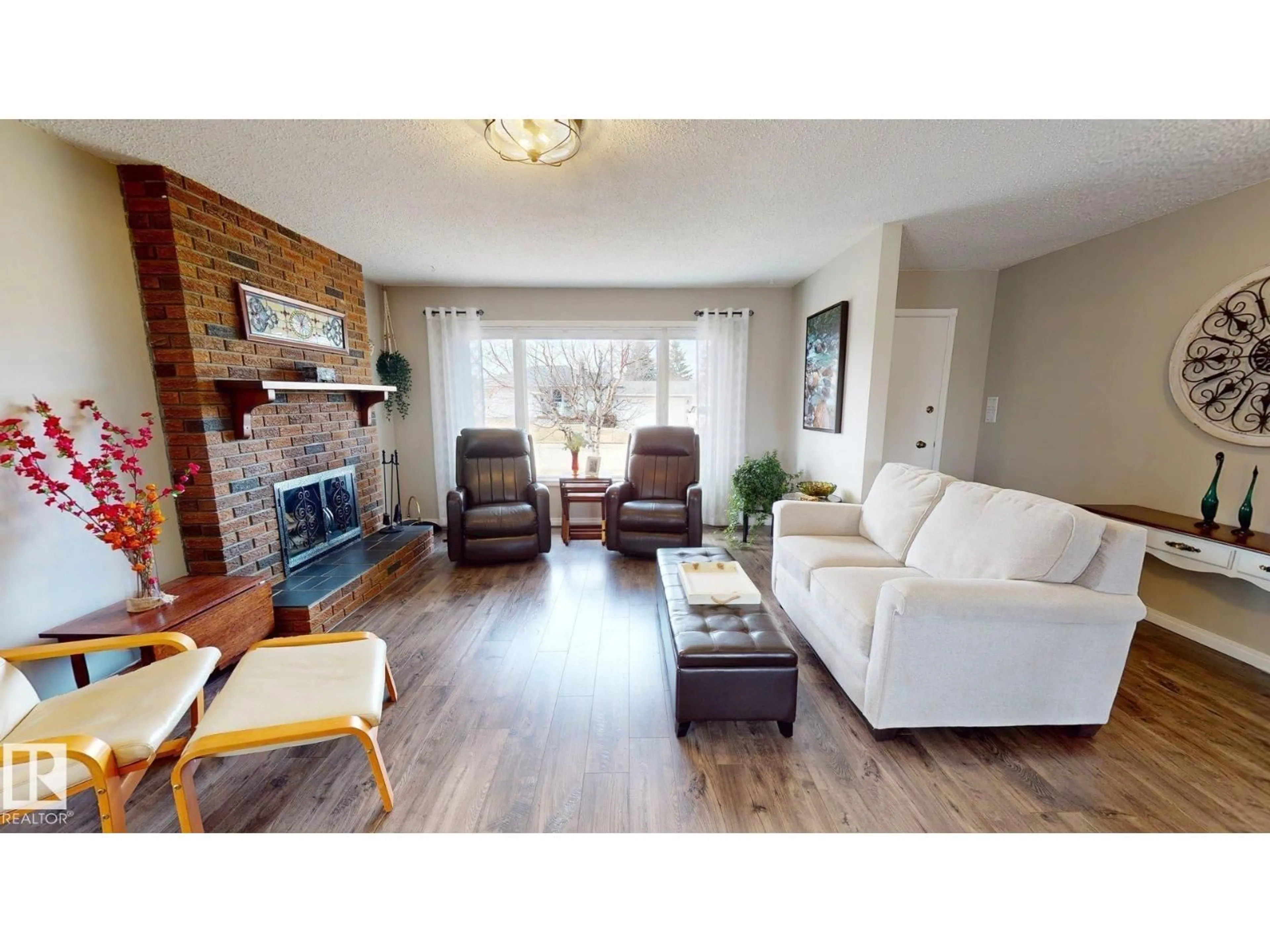 Living room with furniture, wood/laminate floor for 107 HILLSIDE DR, Millet Alberta T0C1Z0