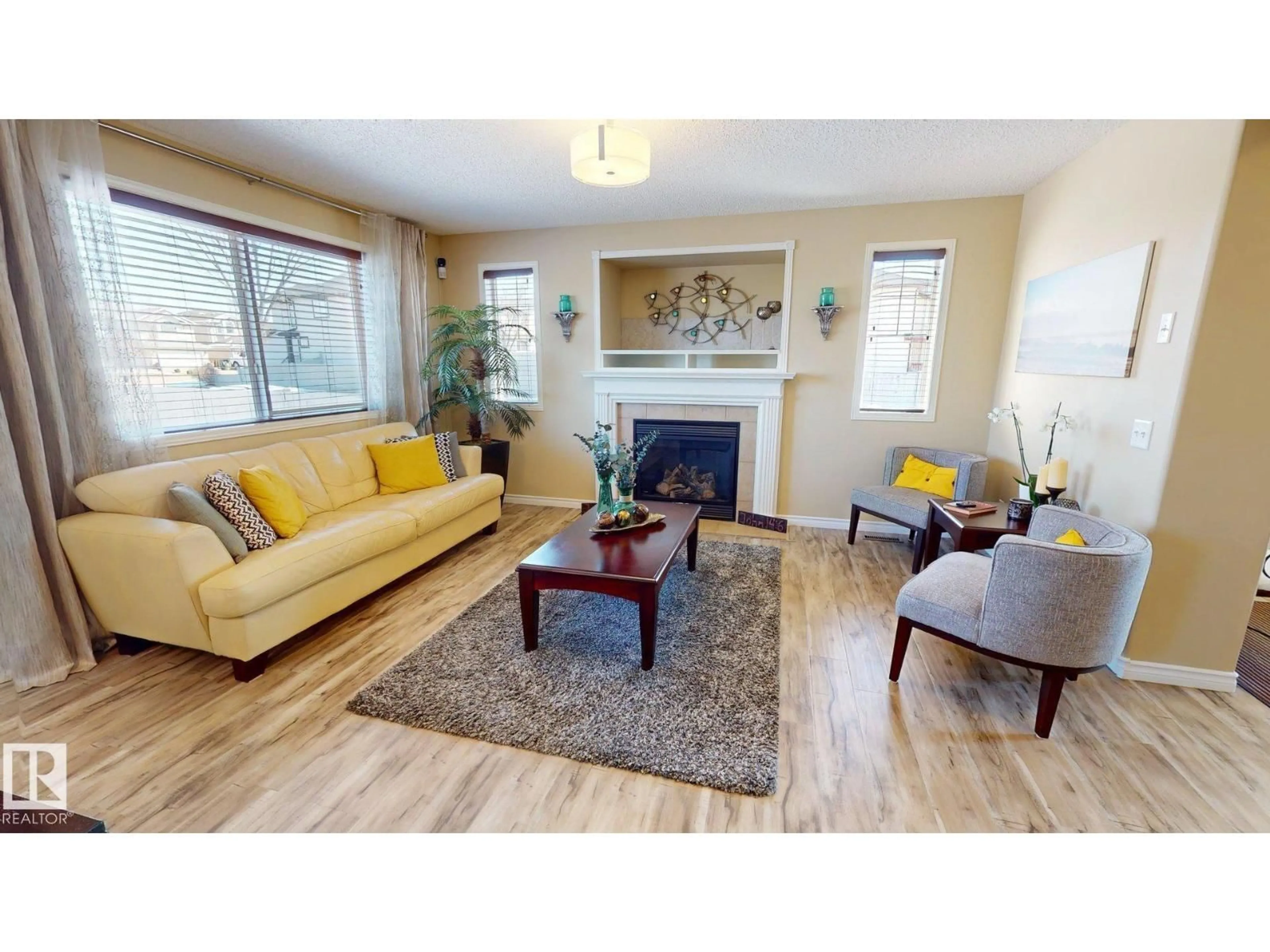 Living room with furniture, wood/laminate floor for 8704 175 AV, Edmonton Alberta T5Z3Z3