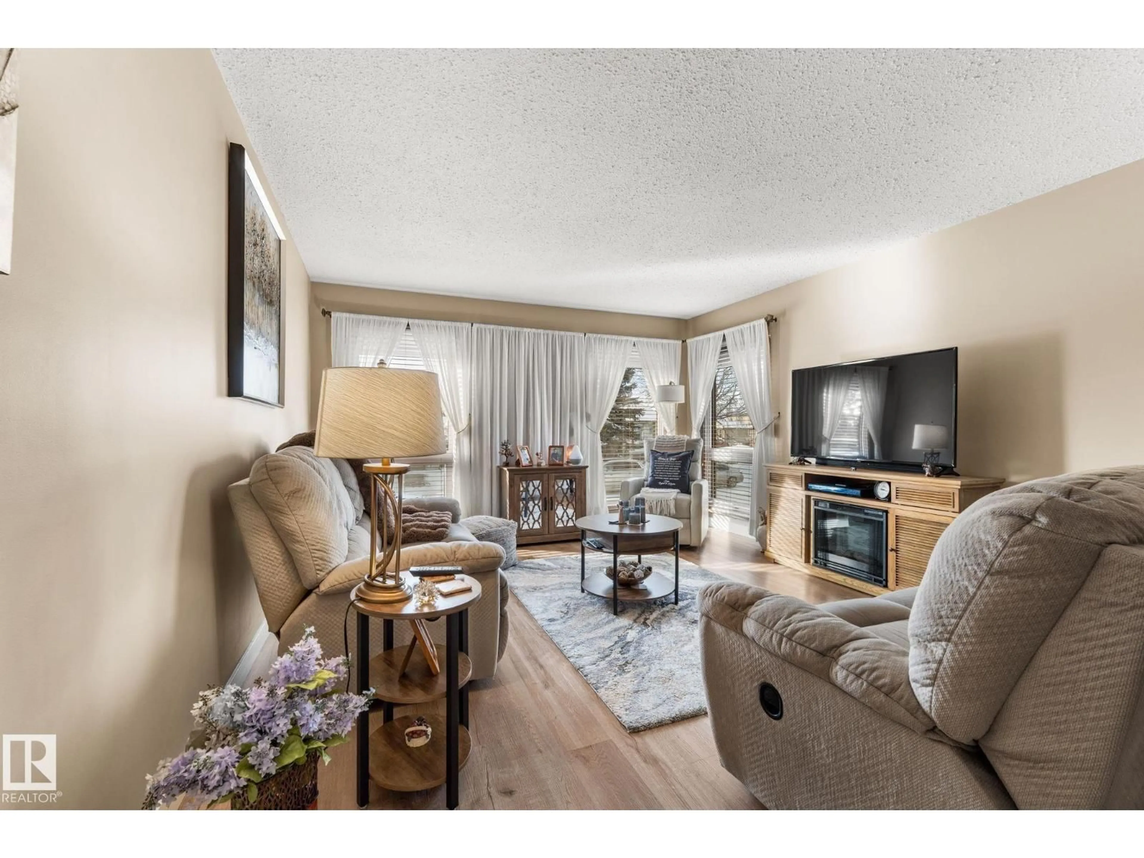 Living room with furniture, wood/laminate floor for 8214 93 AV, Fort Saskatchewan Alberta T8L3P1