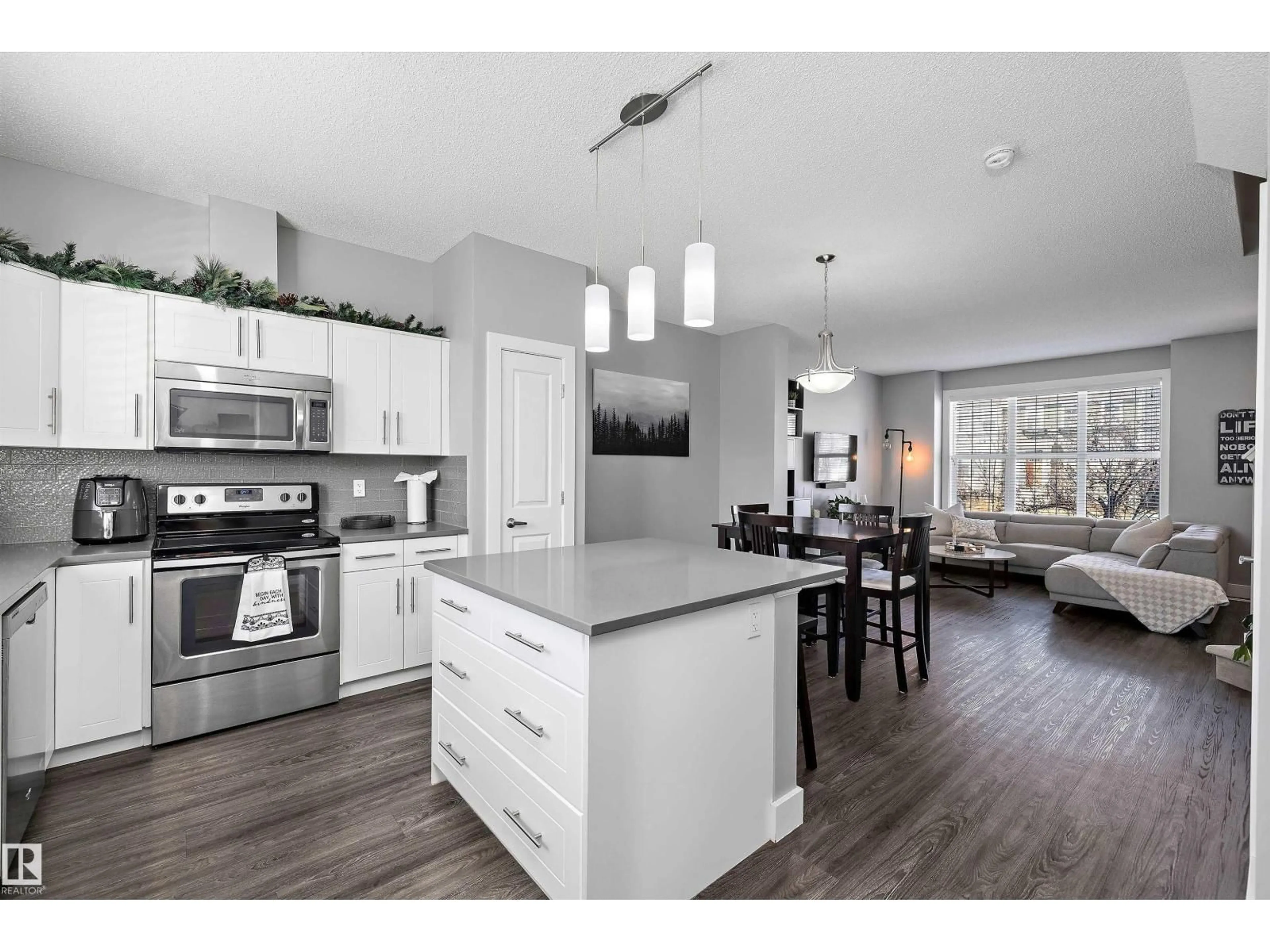 Open concept kitchen, wood/laminate floor for 2107 24 ST, Edmonton Alberta T6T0Y8