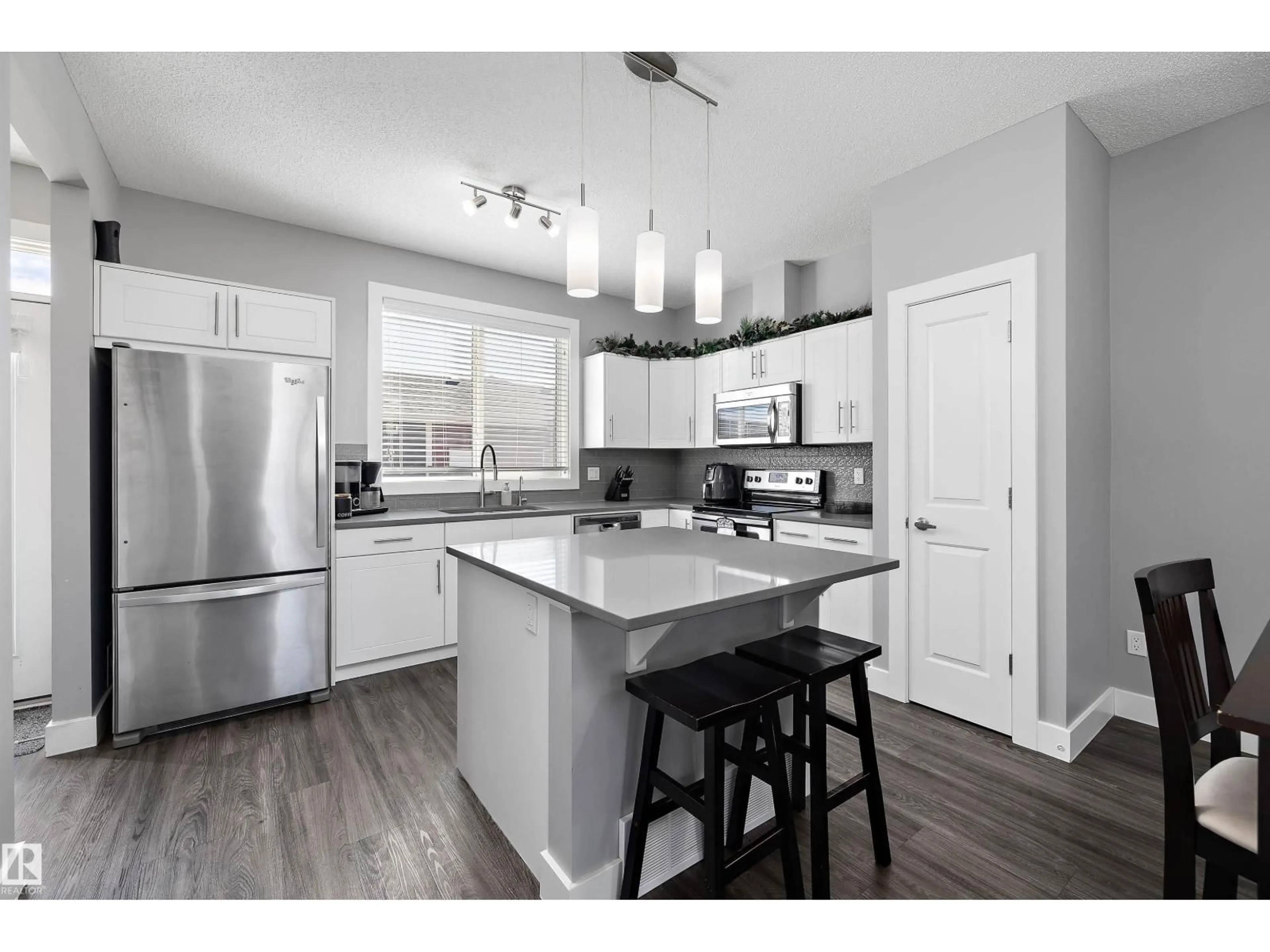 Open concept kitchen, wood/laminate floor for 2107 24 ST, Edmonton Alberta T6T0Y8