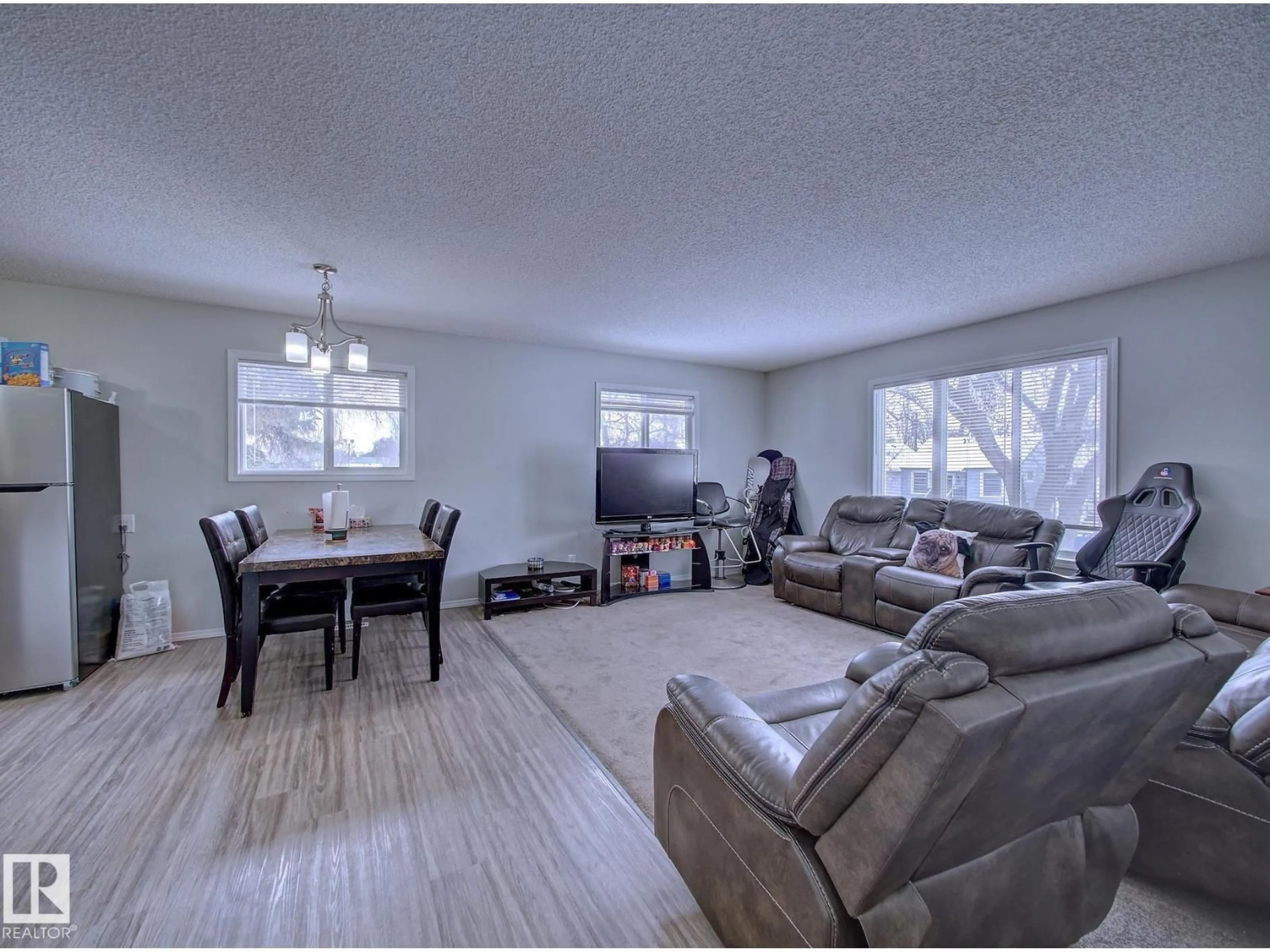 Living room with furniture, wood/laminate floor for NW - 11710 92 ST, Edmonton Alberta T5G1A3
