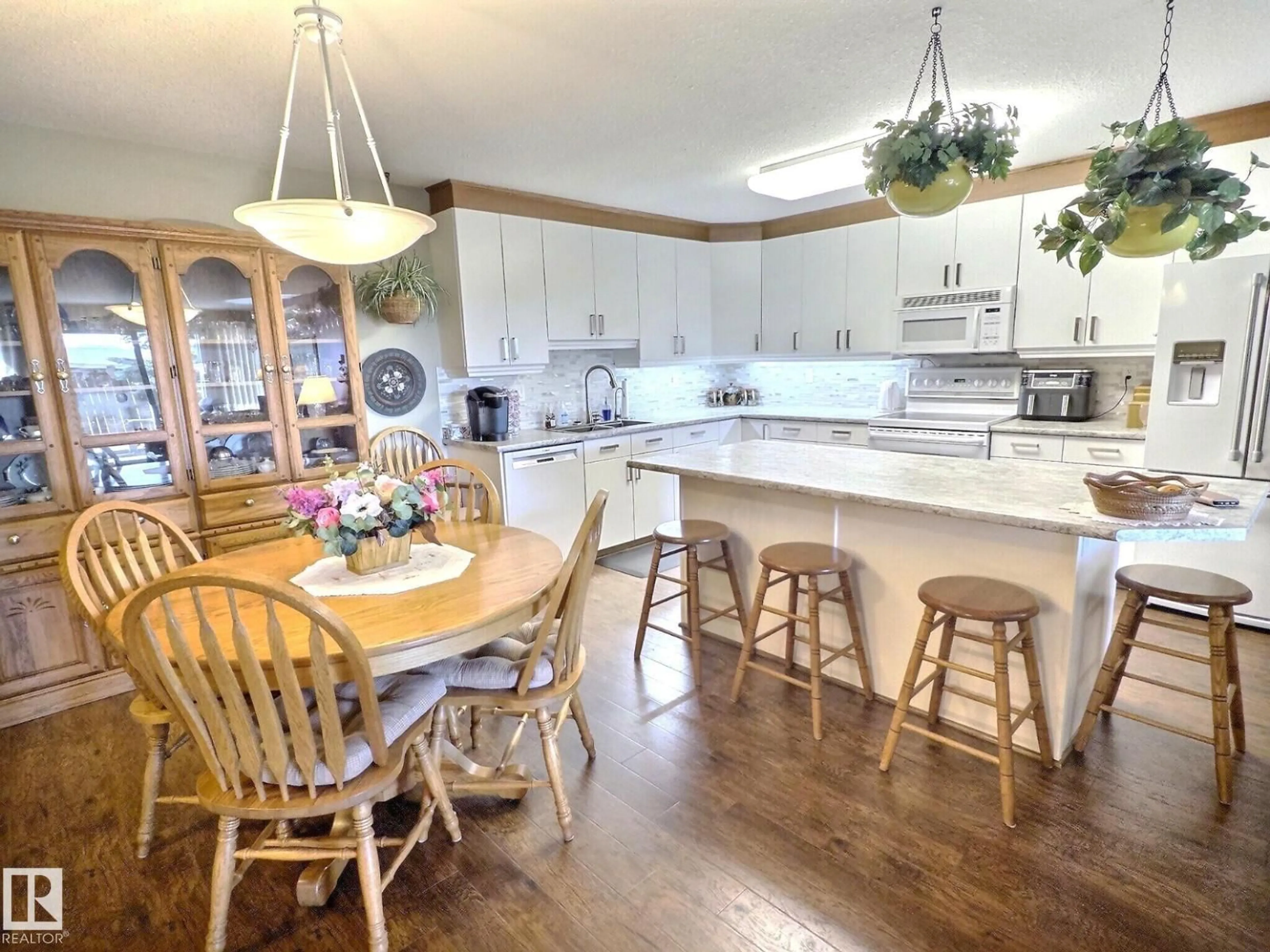 Open concept kitchen, wood/laminate floor for #108 - 8922 156 ST, Edmonton Alberta T5R5Z3