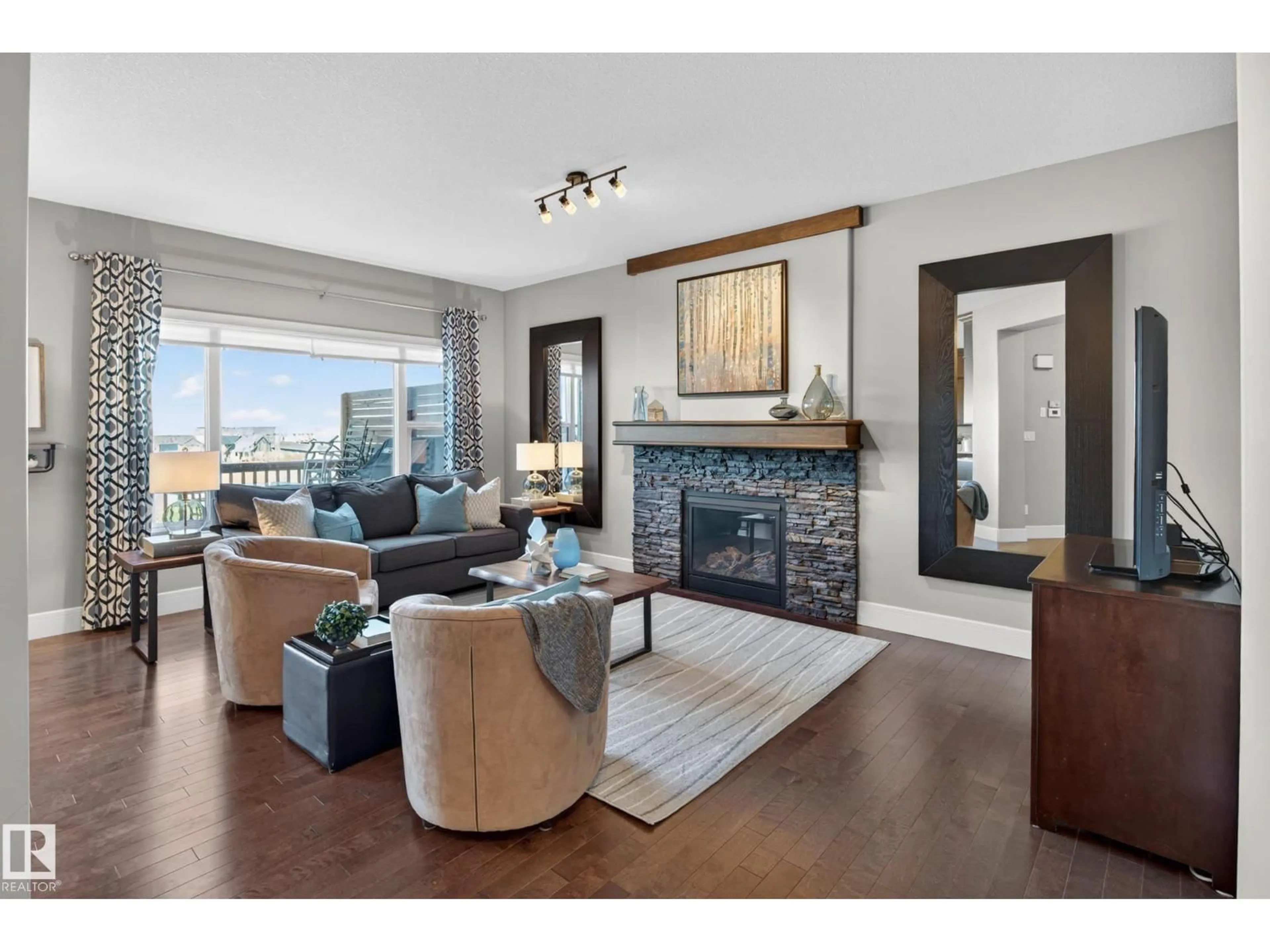 Living room with furniture, wood/laminate floor for NW - 2086 REDTAIL CM, Edmonton Alberta T5S0H4