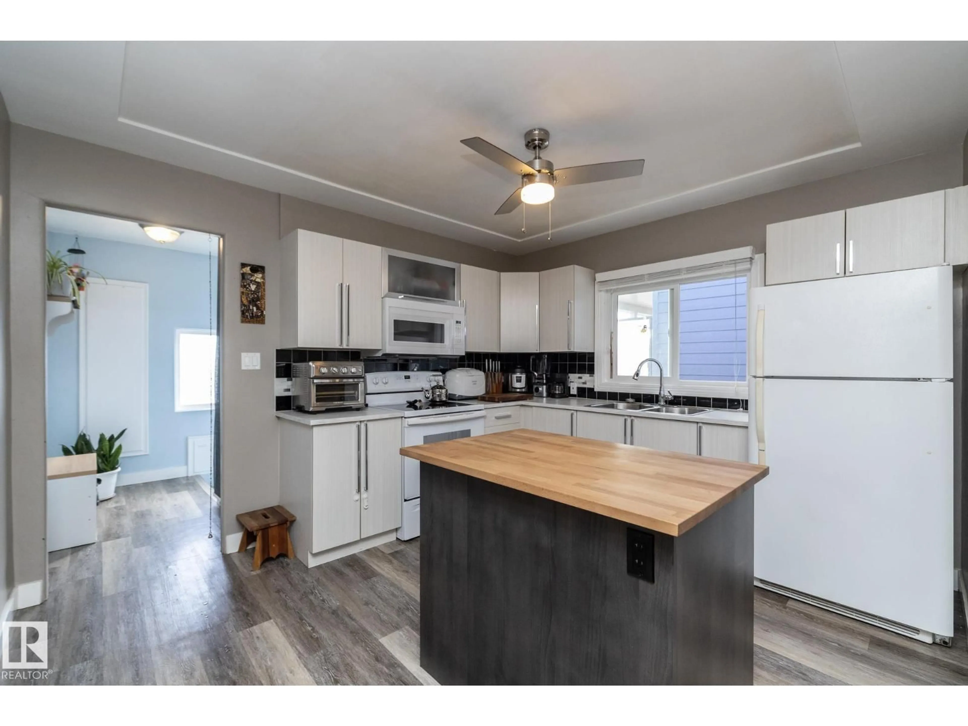 Open concept kitchen, wood/laminate floor for 10103 108 ST, Fort Saskatchewan Alberta T8L2V7