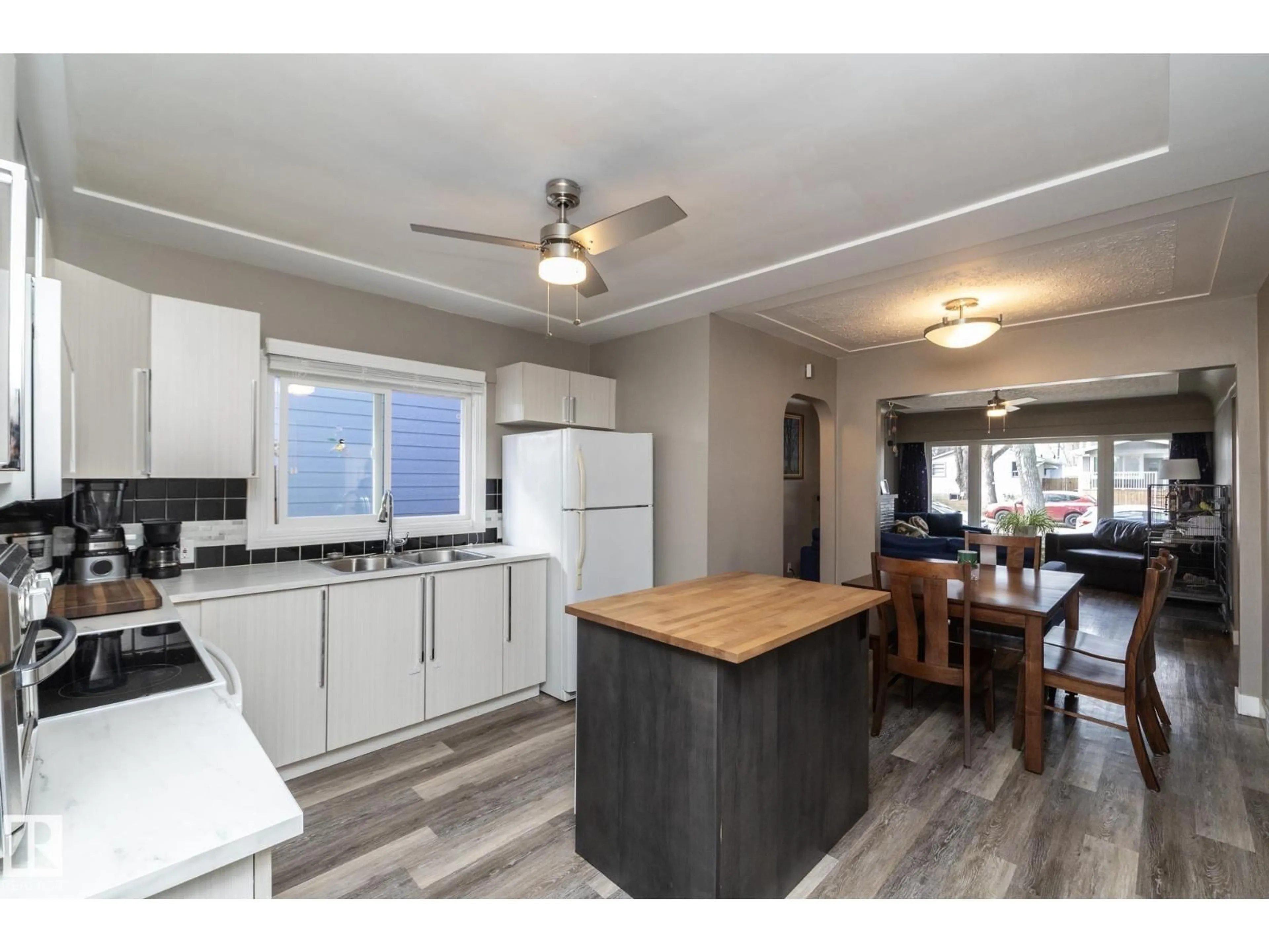 Open concept kitchen, wood/laminate floor for 10103 108 ST, Fort Saskatchewan Alberta T8L2V7