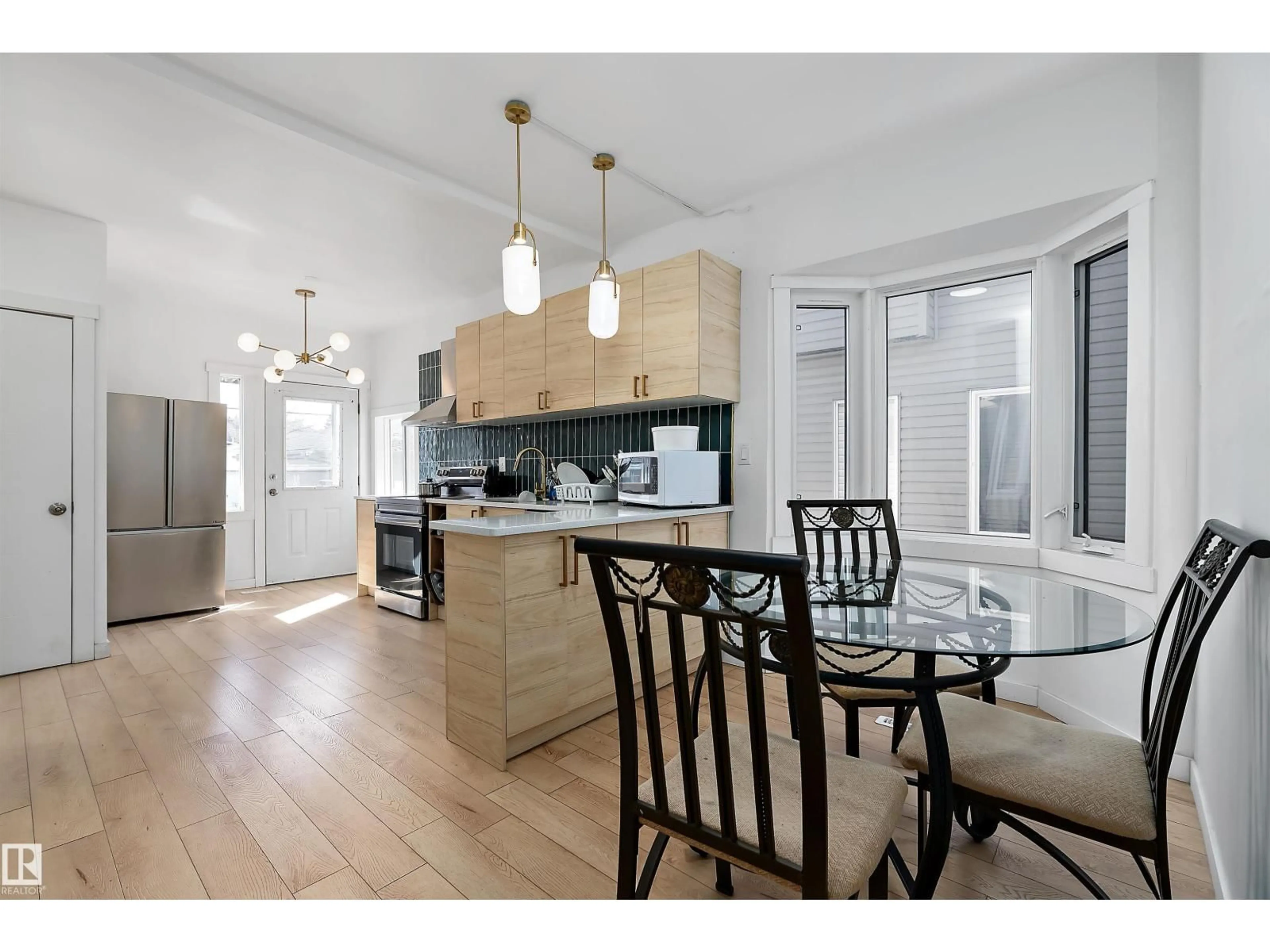 Open concept kitchen, wood/laminate floor for 11919 96 ST, Edmonton Alberta T5G1V6