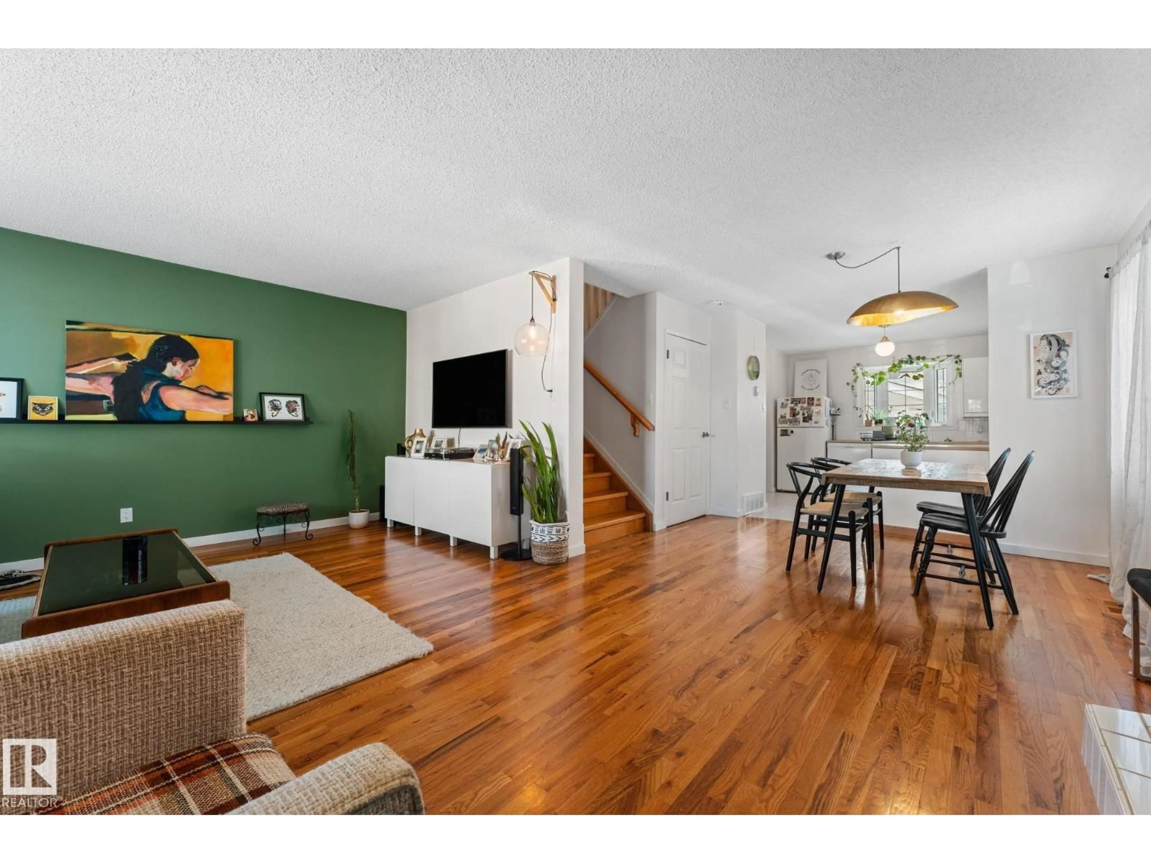 Living room with furniture, wood/laminate floor for 8759 92 AV, Edmonton Alberta T6C1S2