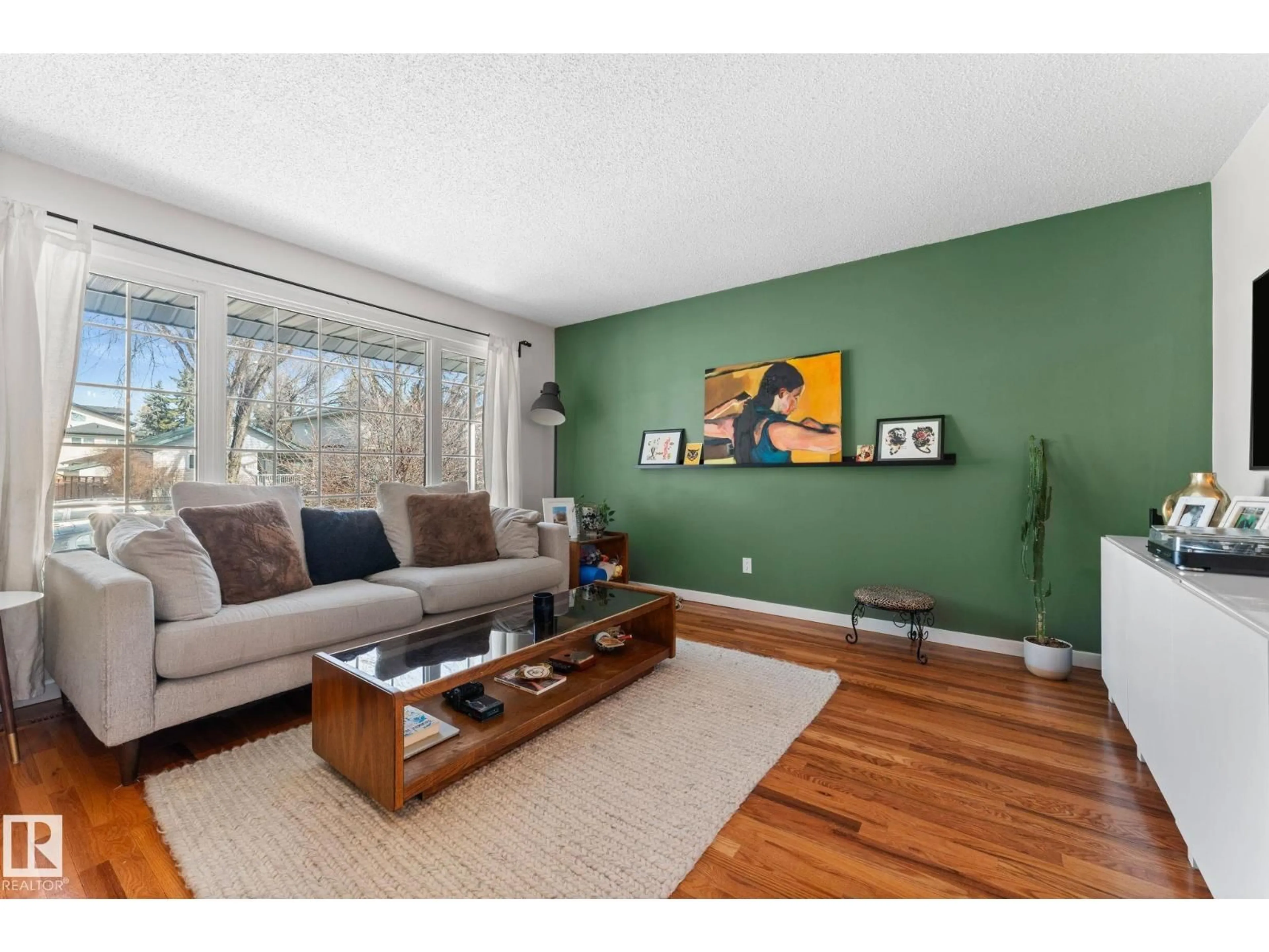 Living room with furniture, wood/laminate floor for 8759 92 AV, Edmonton Alberta T6C1S2