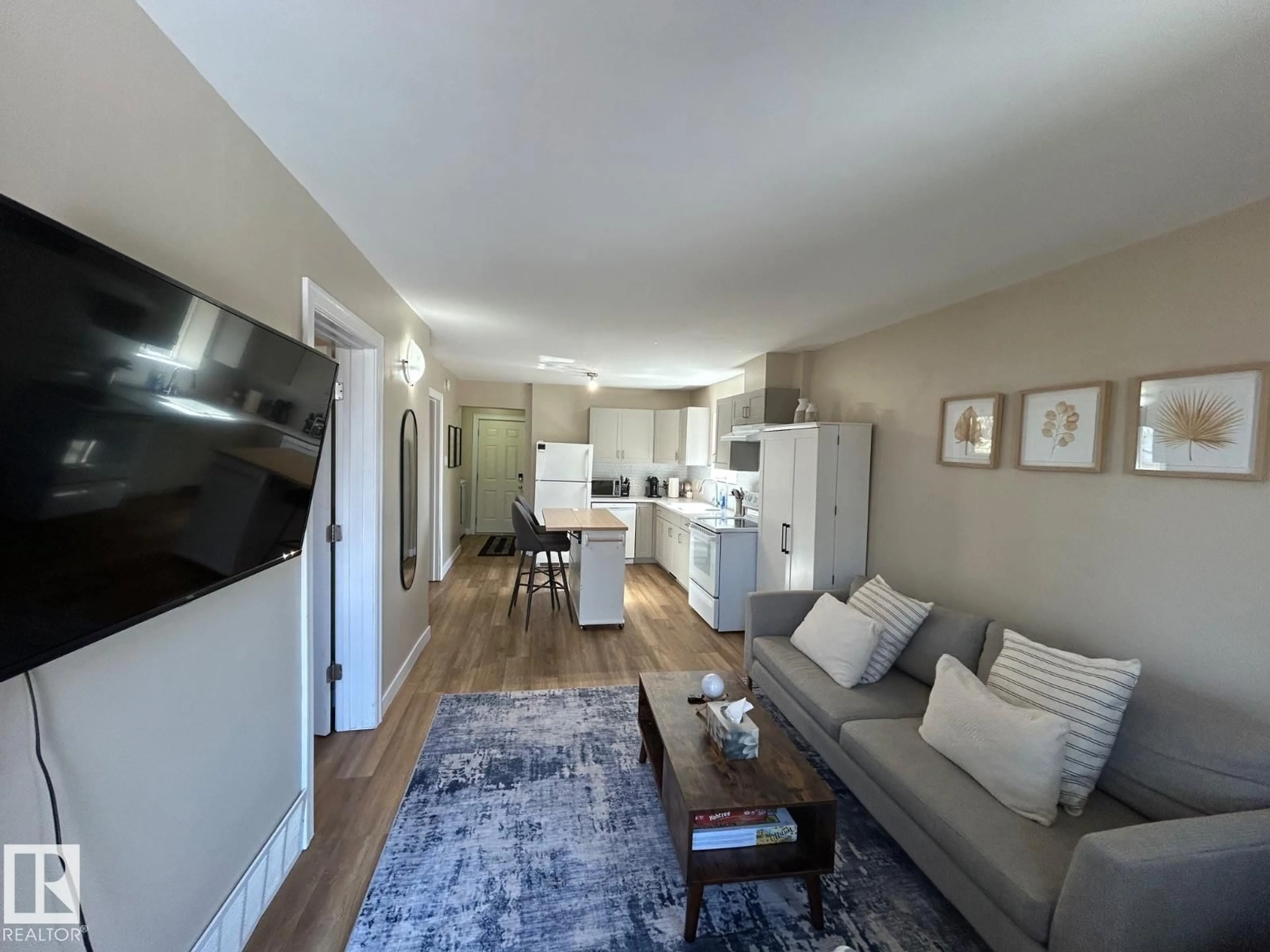 Living room with furniture, wood/laminate floor for 11017 38 ST NW, Edmonton Alberta T5W2E7