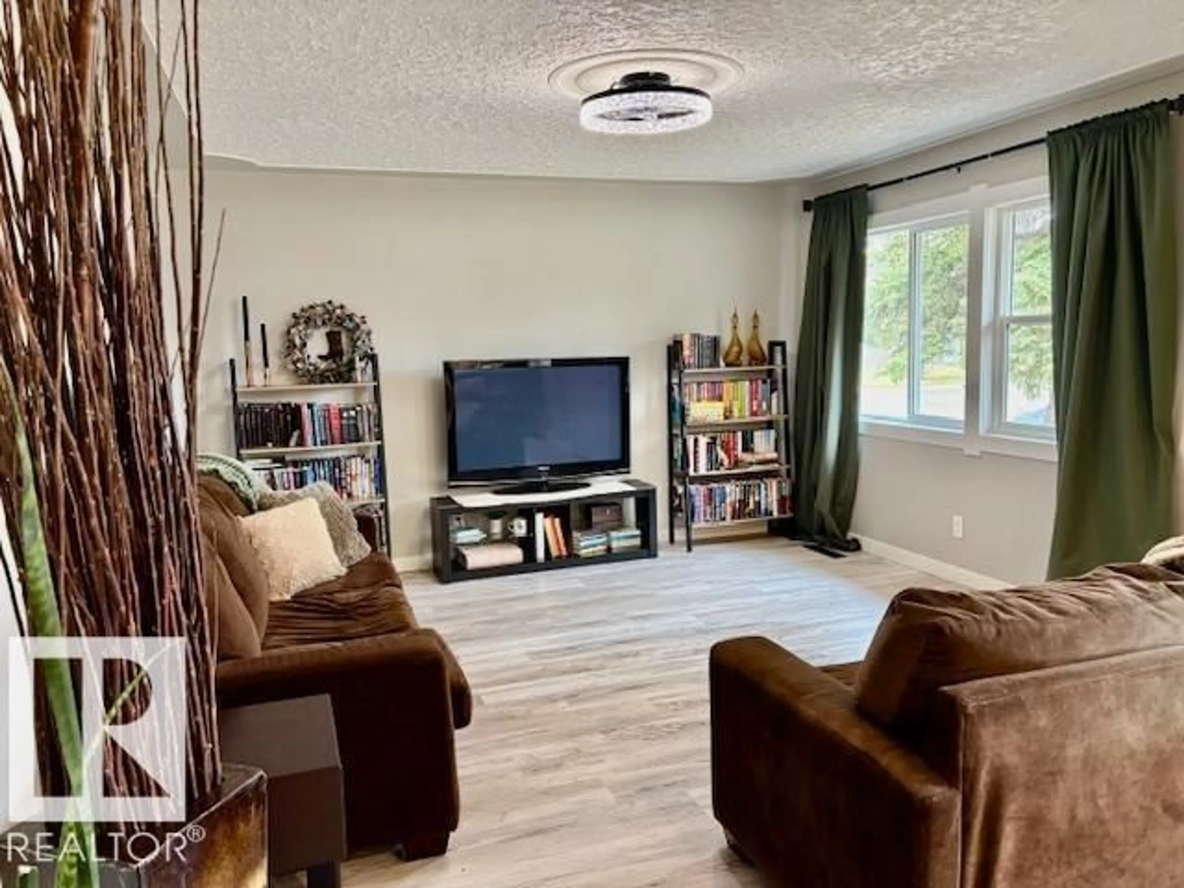 Living room with furniture, wood/laminate floor for 5626 49A ST, Vegreville Alberta T9C1K4