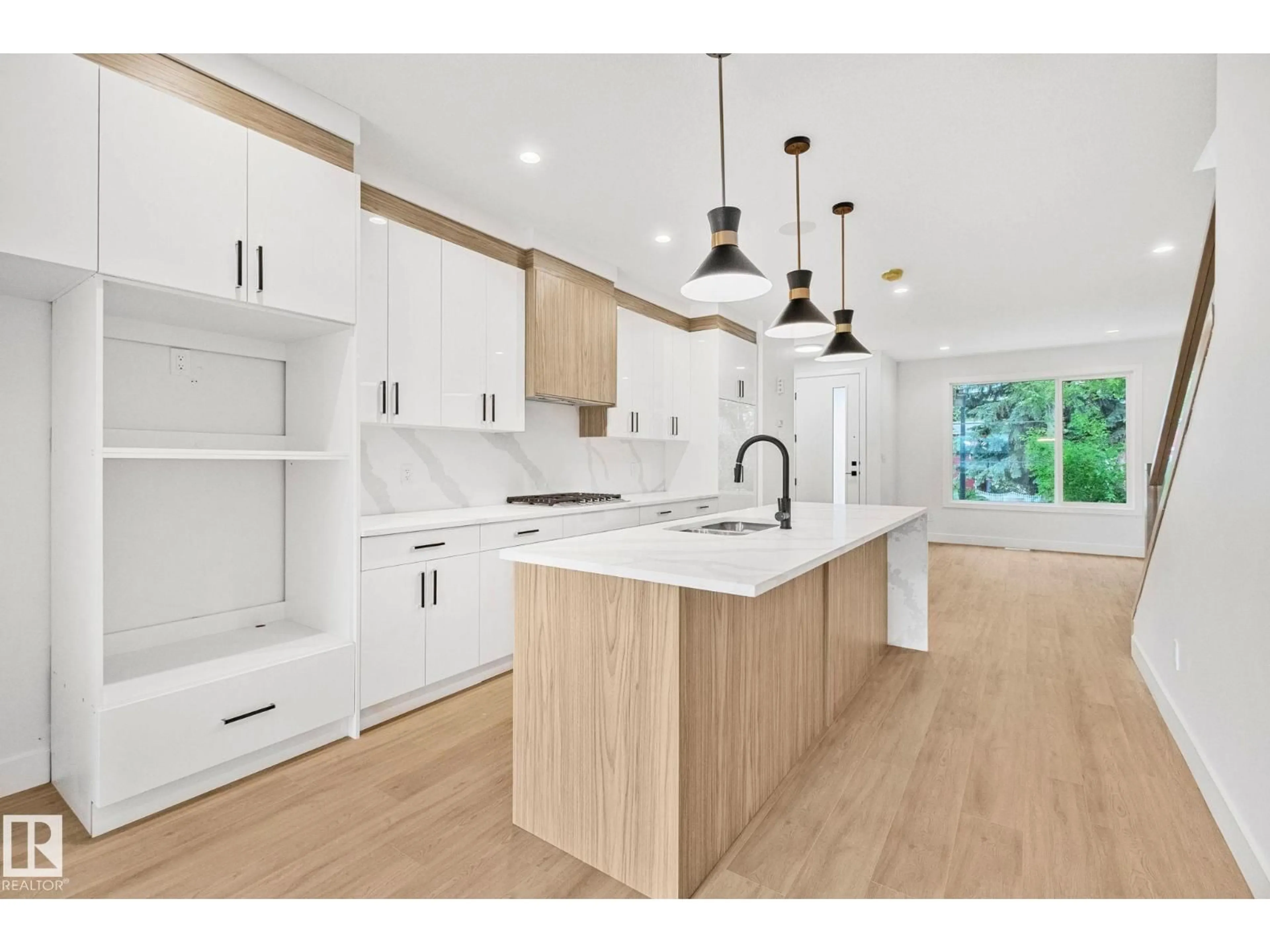 Open concept kitchen, wood/laminate floor for 11138 126 ST, Edmonton Alberta T5M0P9