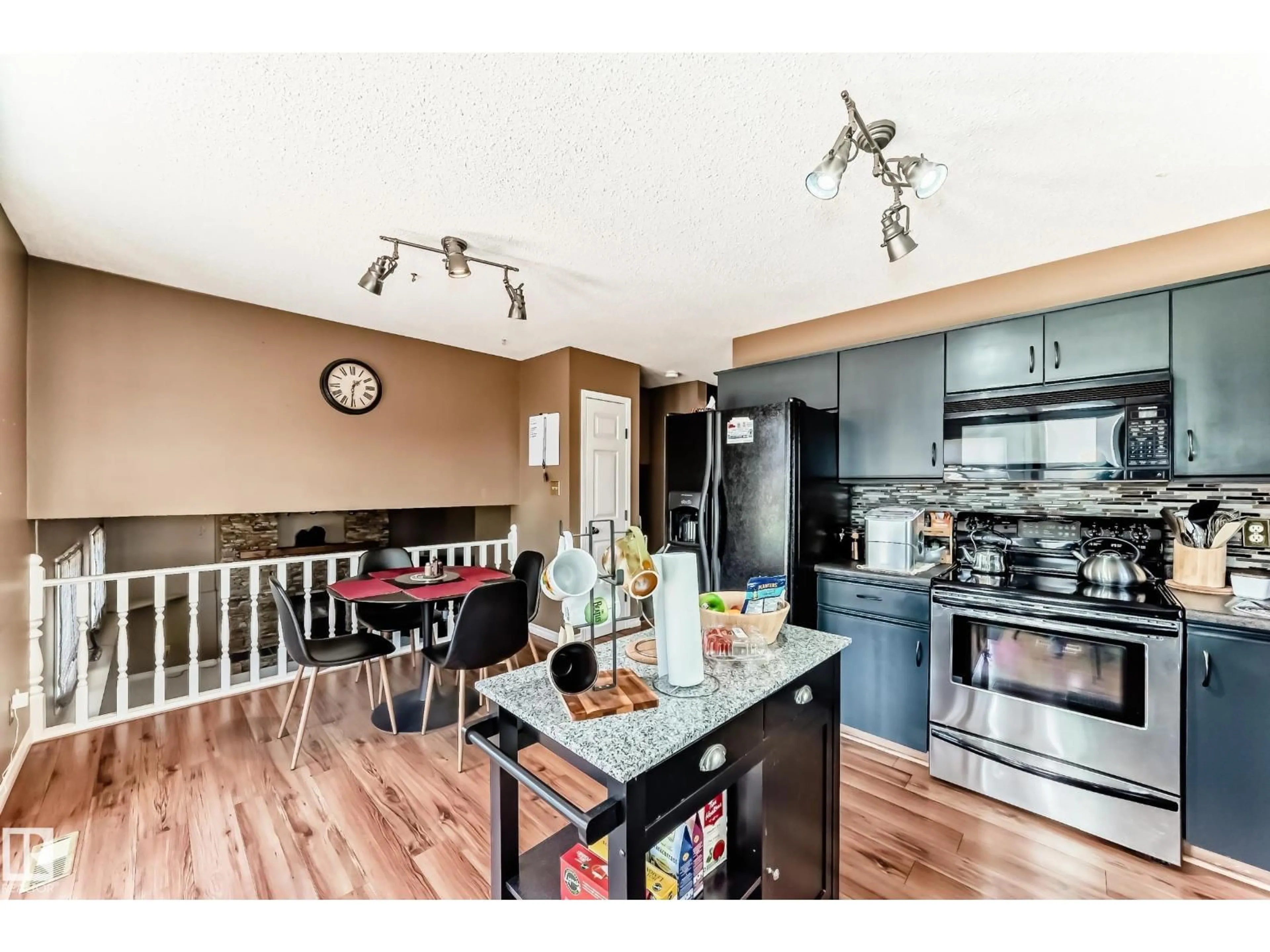 Open concept kitchen, wood/laminate floor for 9845 184 ST, Edmonton Alberta T5T4L5