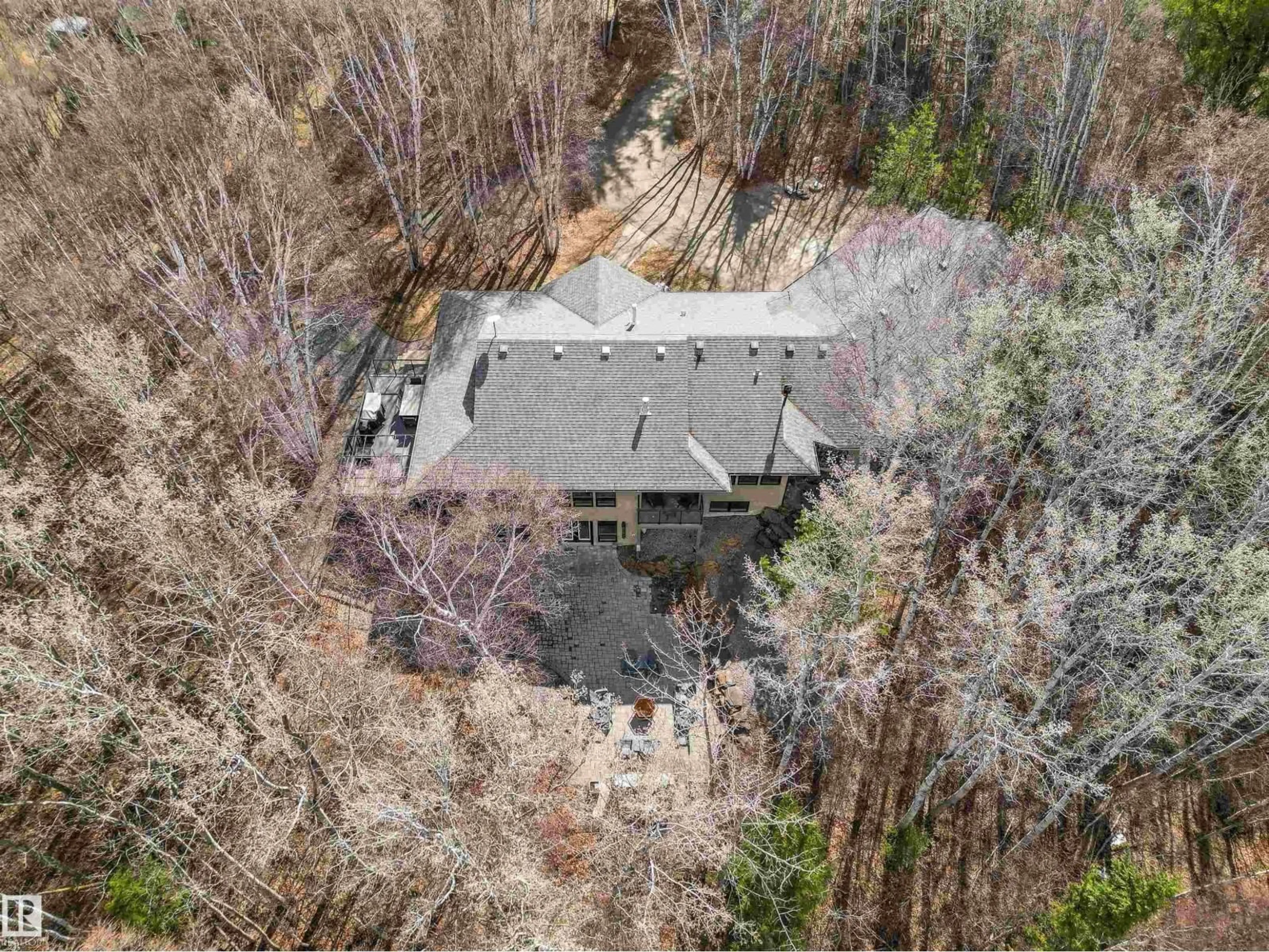 A pic from outside/outdoor area/front of a property/back of a property/a pic from drone, forest/trees view for 9 - 26516 TWP ROAD 514, Rural Parkland County Alberta T7Y1E9