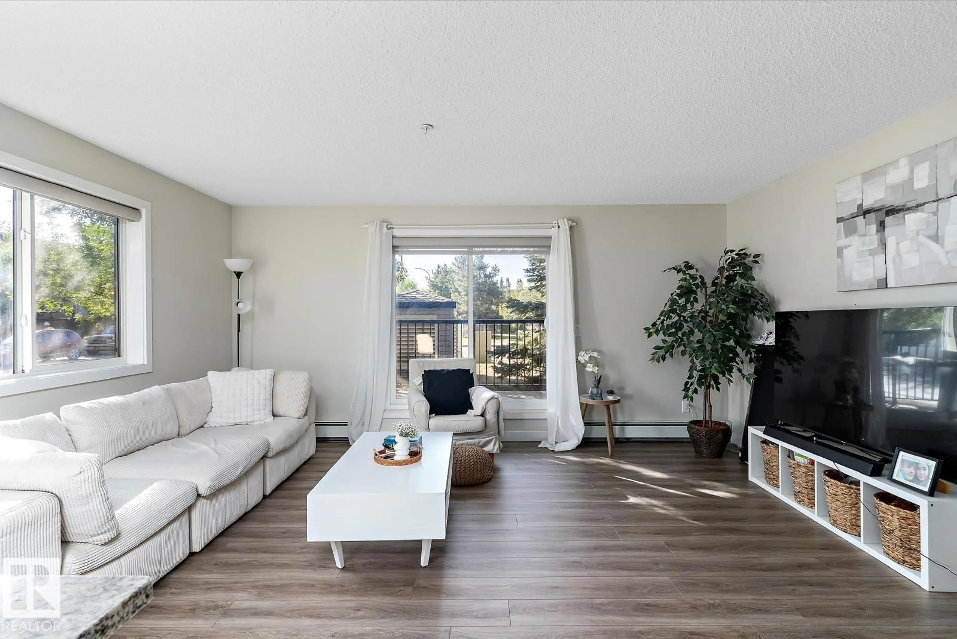 Living room with furniture, wood/laminate floor for #110 - 14808 125 ST NW, Edmonton Alberta T5X0G1