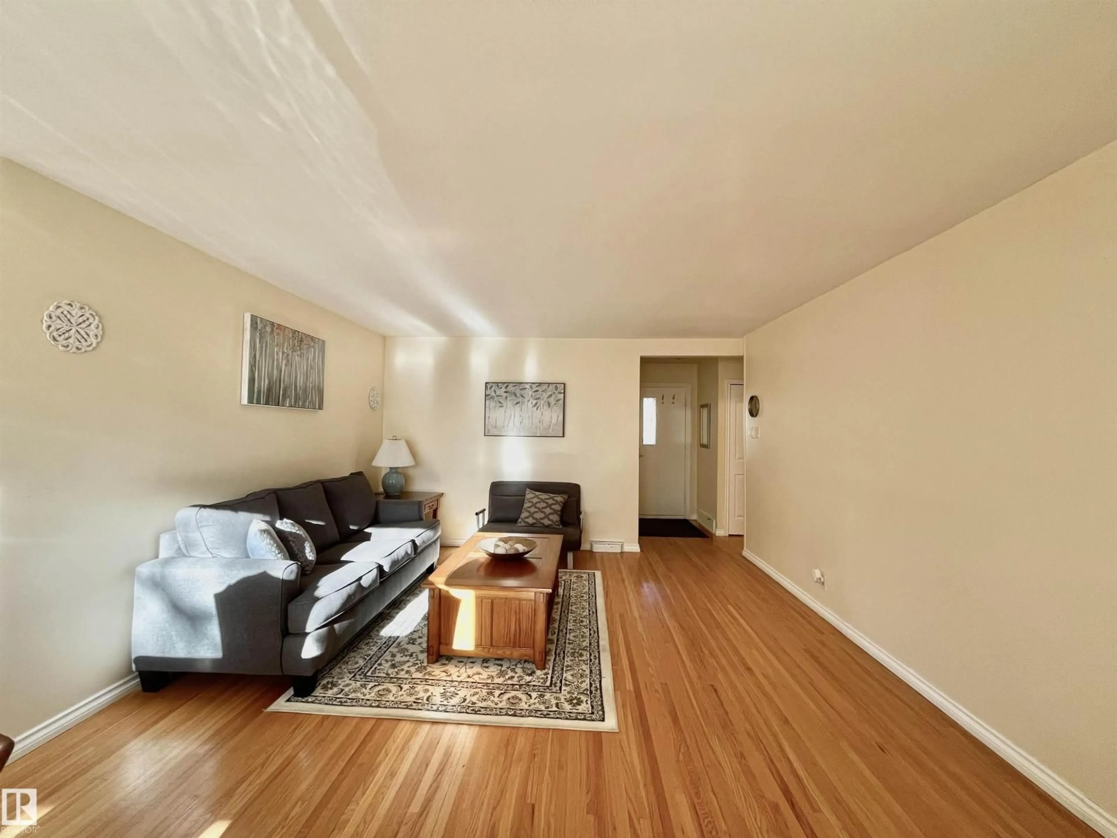 Living room with furniture, wood/laminate floor for 11681 72 AV, Edmonton Alberta T6G0B9