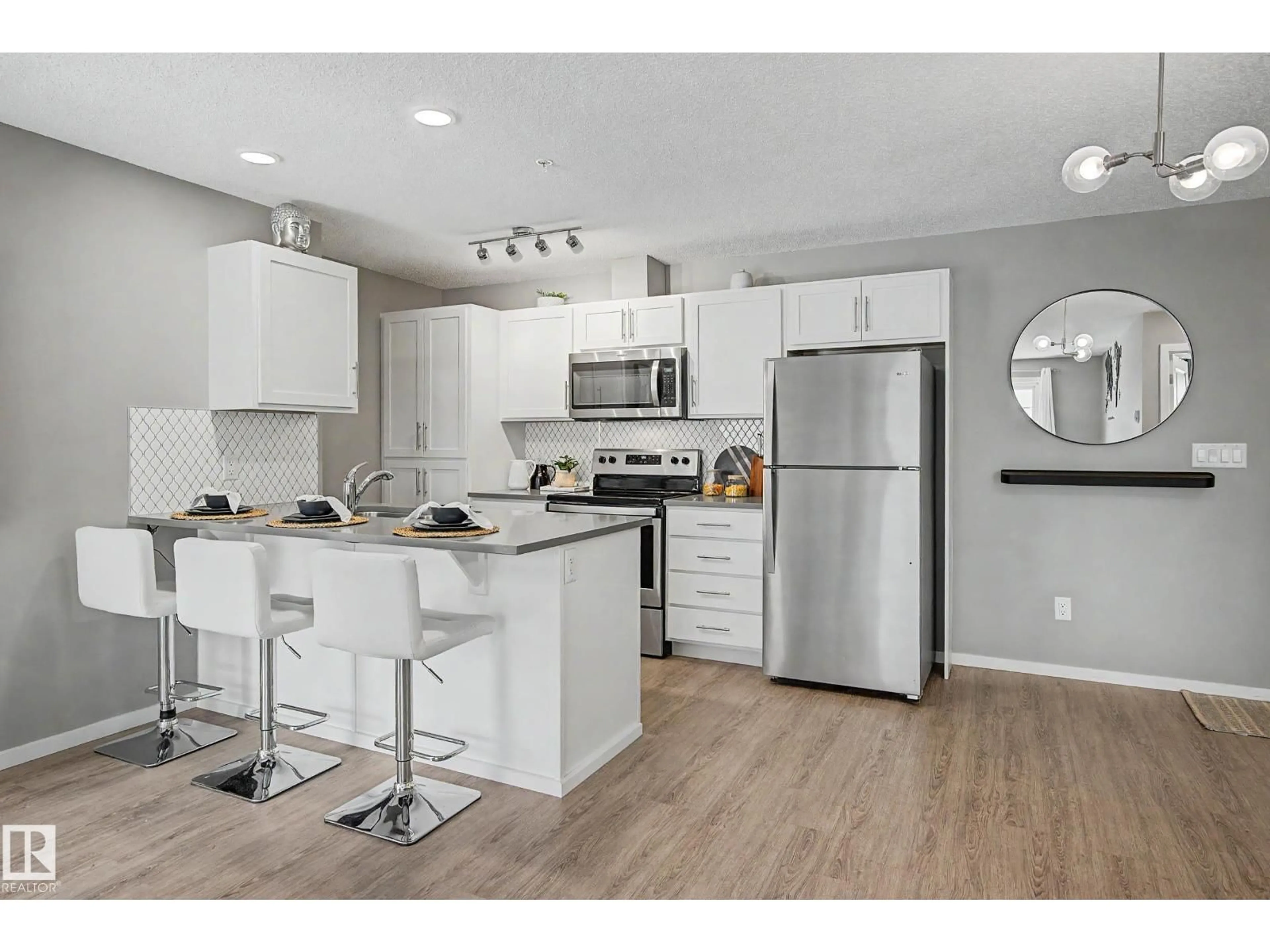 Open concept kitchen, wood/laminate floor for 217 - 394 WINDERMERE RD, Edmonton Alberta T6W0R1