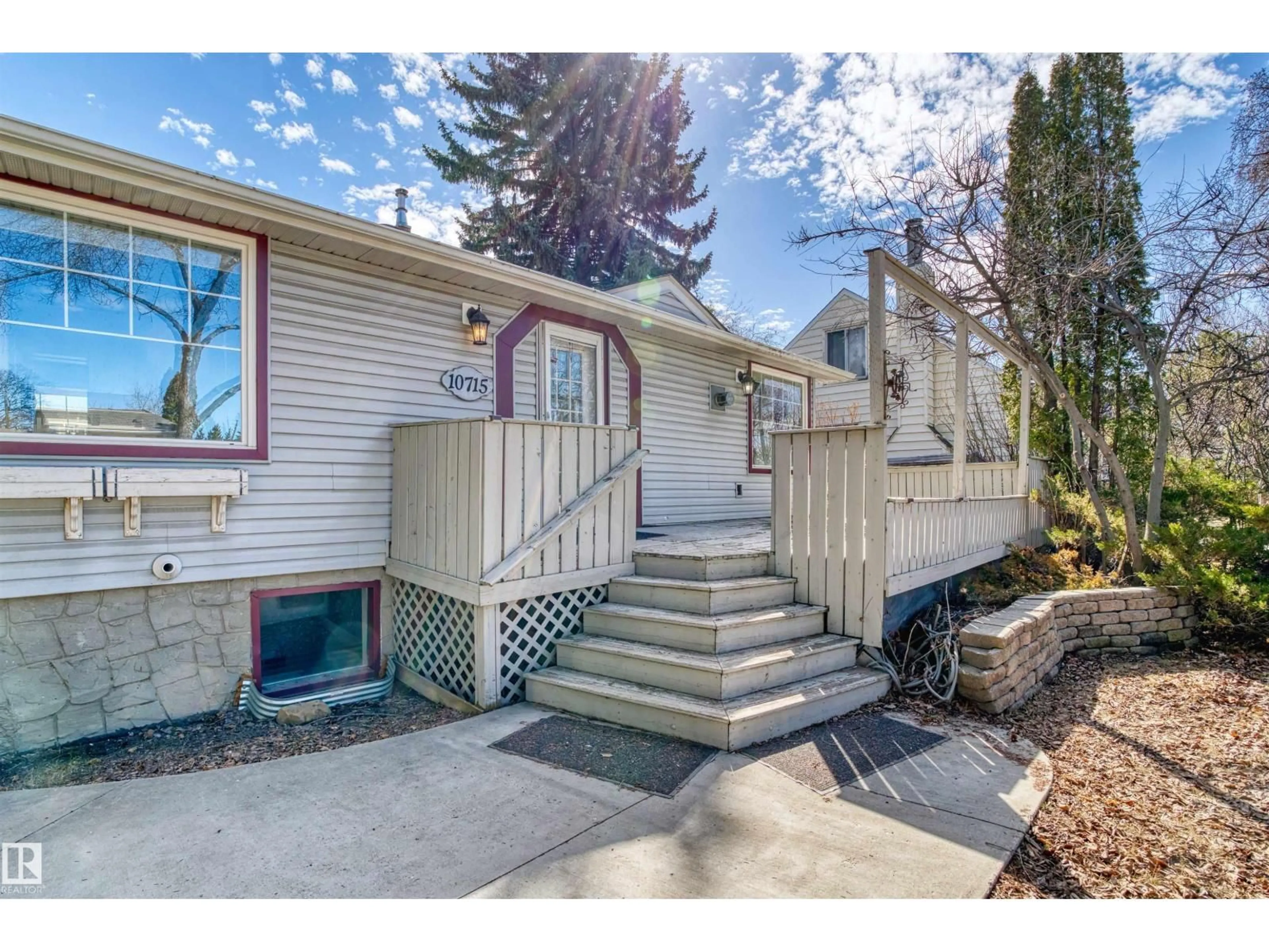 Home with vinyl exterior material, street for 10715 135 ST, Edmonton Alberta T5M1J7