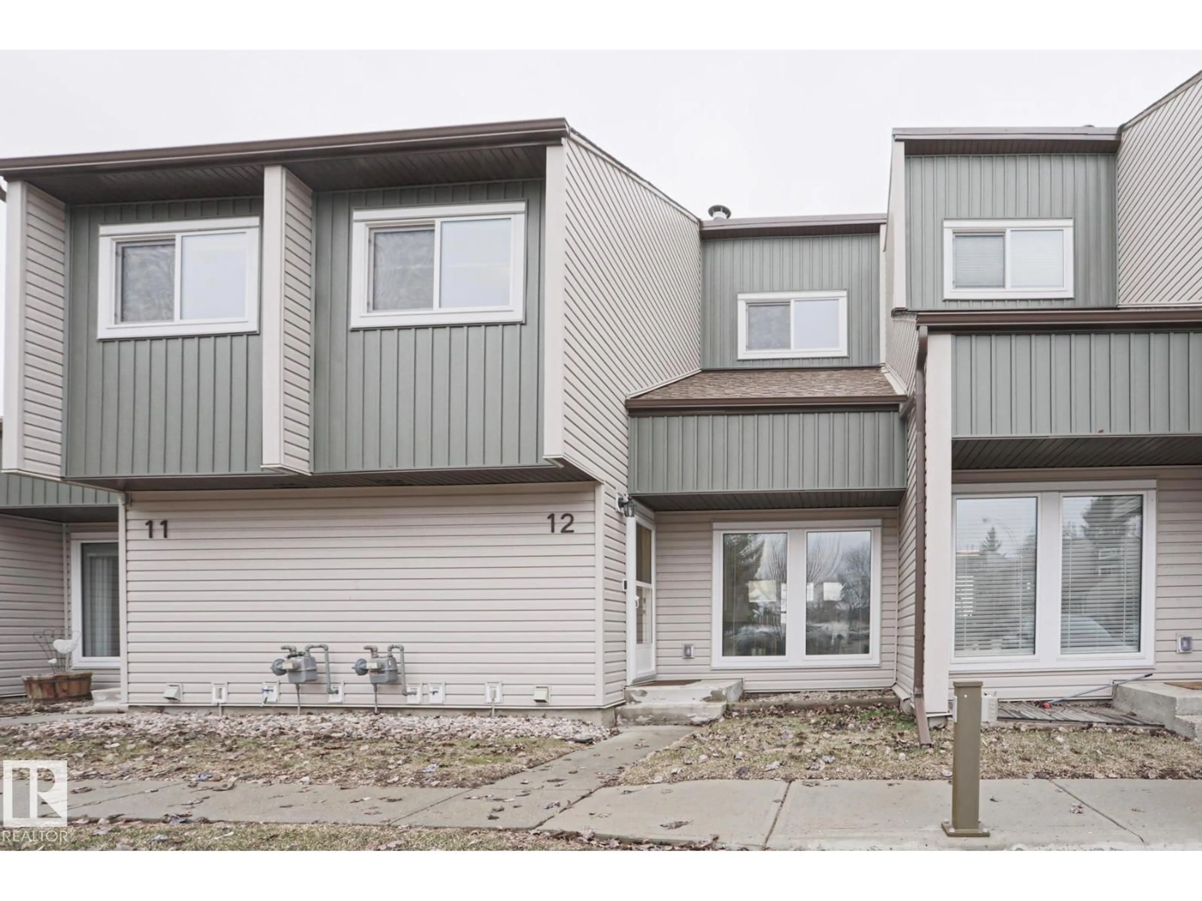 Home with vinyl exterior material, street for 12 2020 105 ST NW, Edmonton Alberta T6J5J2