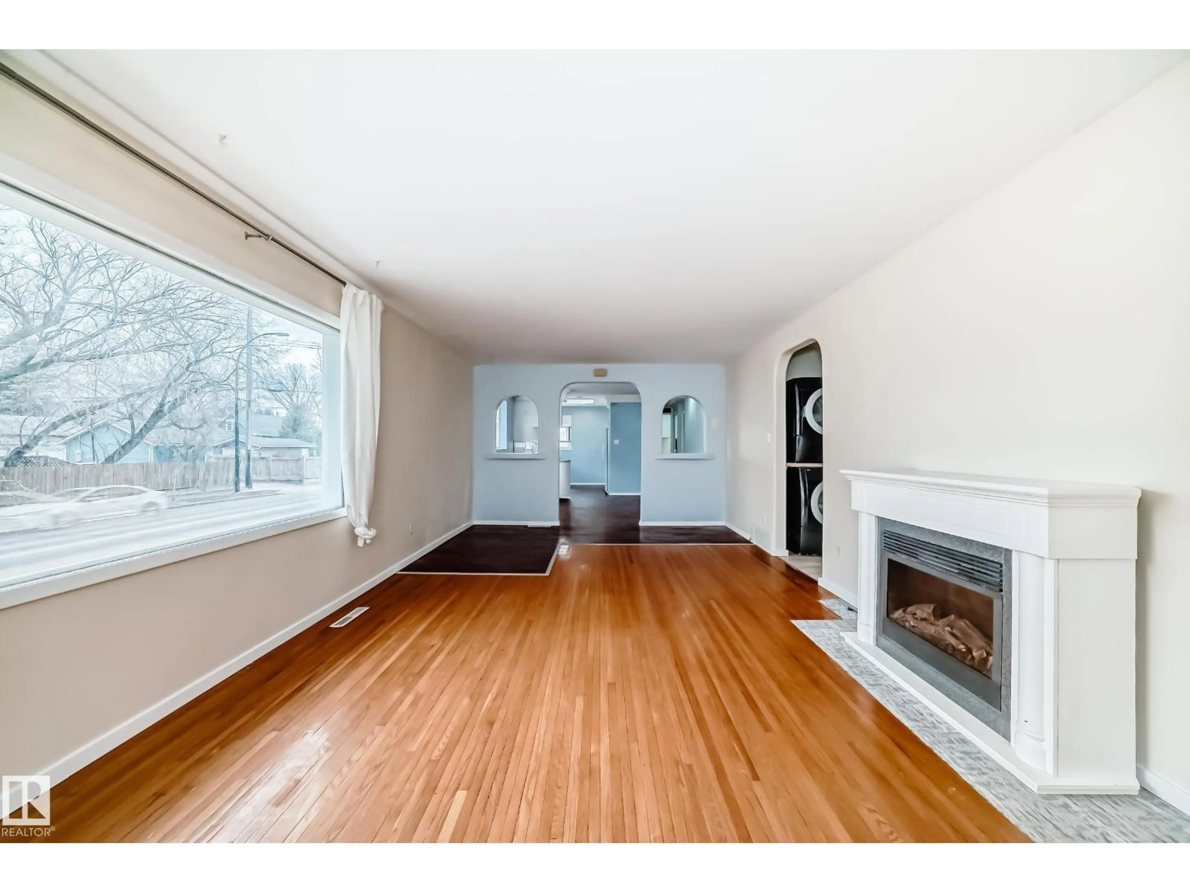 Living room with furniture, wood/laminate floor for 5204 112 AV, Edmonton Alberta T5W0N5