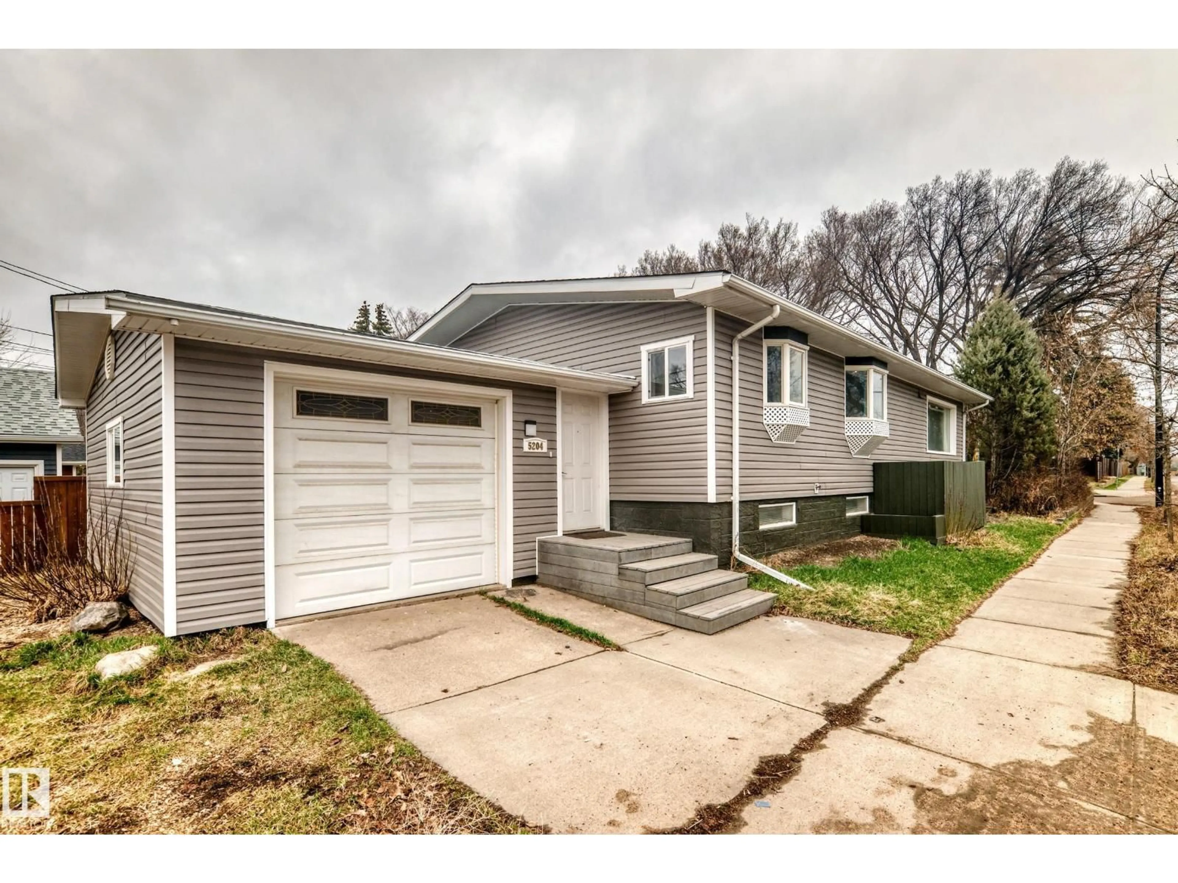 Home with vinyl exterior material, street for 5204 112 AV, Edmonton Alberta T5W0N5