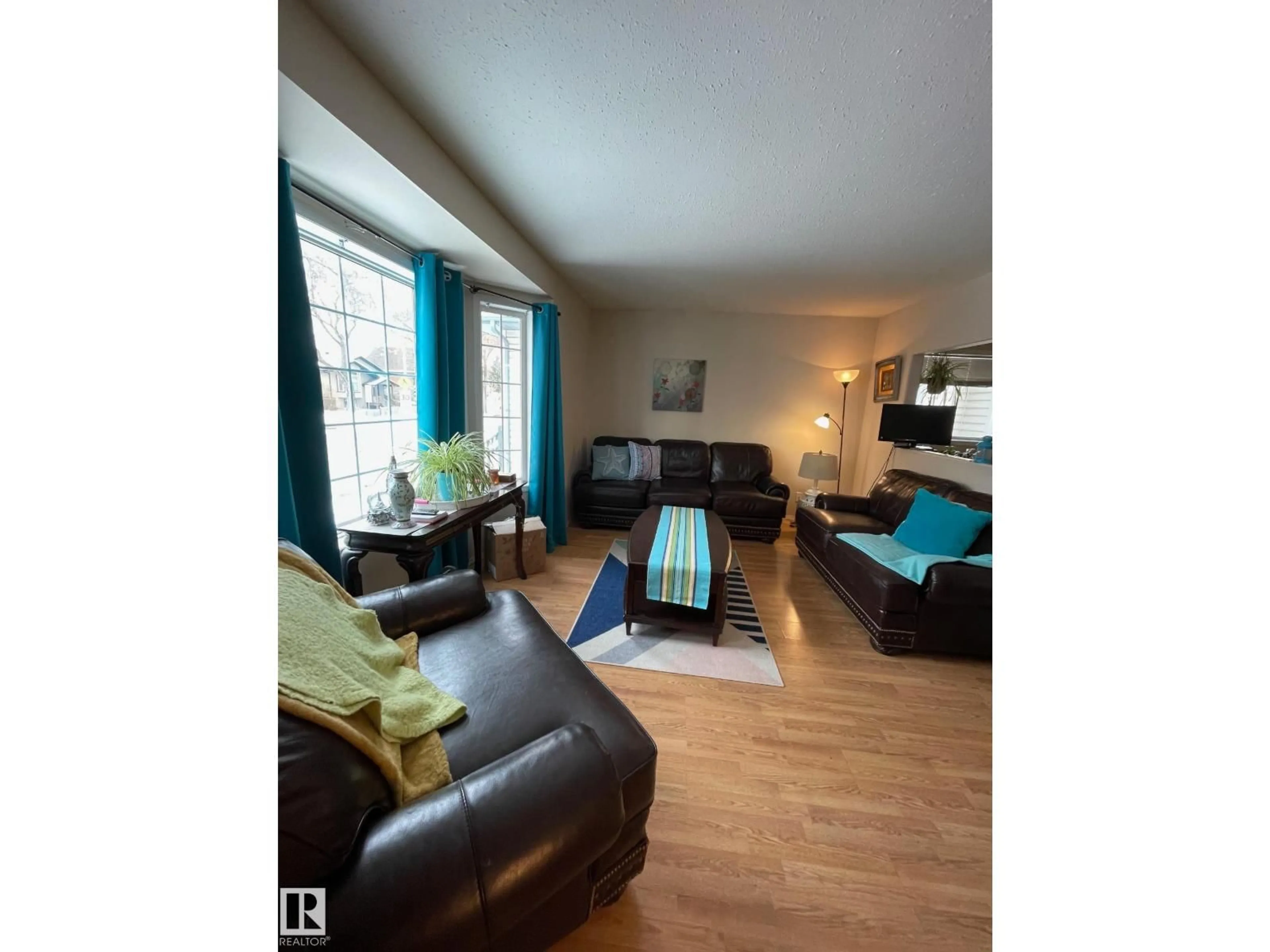 Living room with furniture, wood/laminate floor for NW - 12005 95A ST, Edmonton Alberta T5G1R6