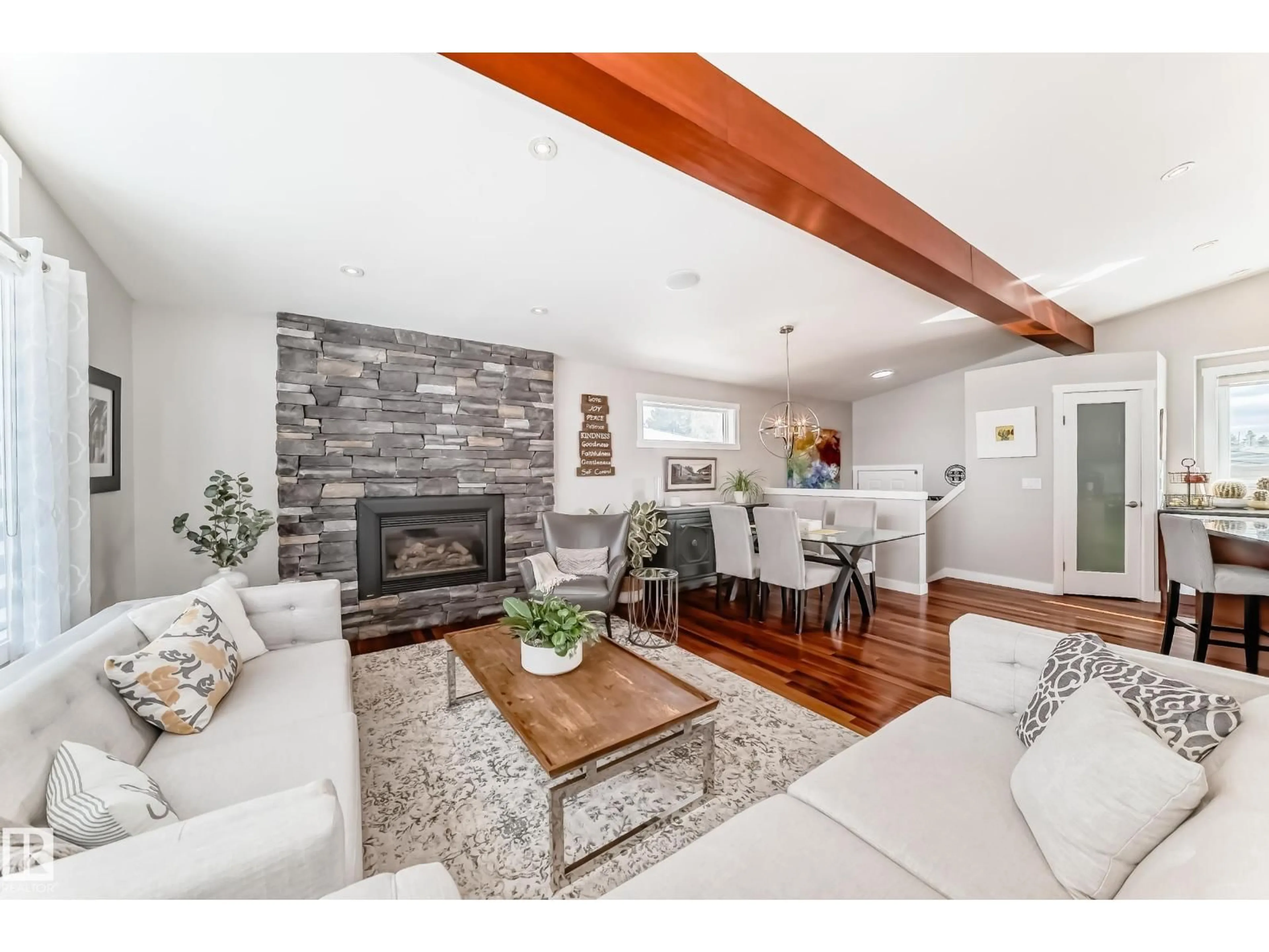 Living room with furniture, wood/laminate floor for 10811 43 AV, Edmonton Alberta T6J2R3